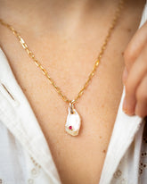January Birthstone Pearl Pendant With Garnet and the 3mm Beveled Oval Chain Necklace styled on model.