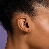 product_details::Poppy Flower Bud Hoop Earrings on model.