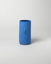 Rami Kim Matte Blue Face Vase on light color background.