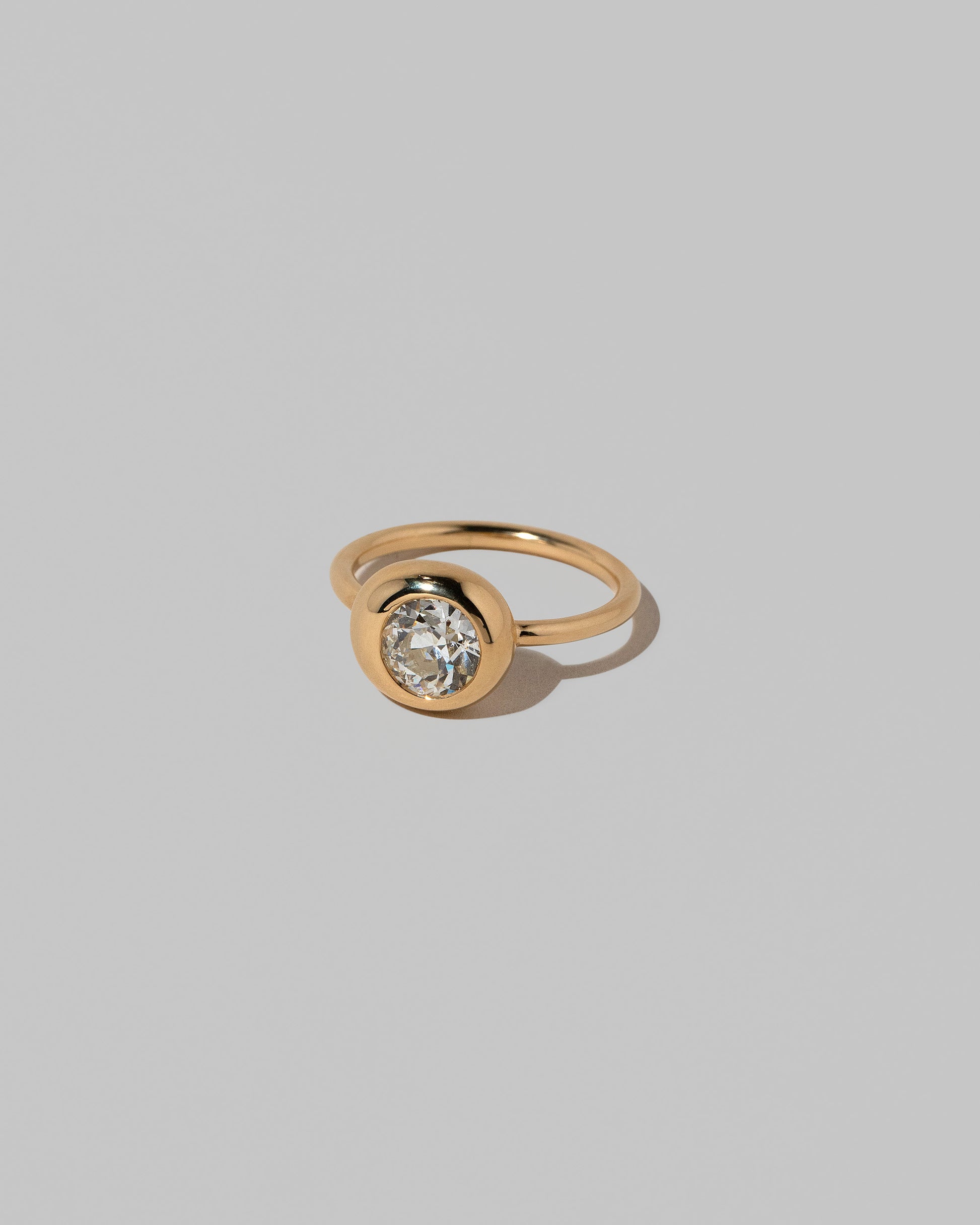 View from the side of the Diamond Level Ring on light color background.