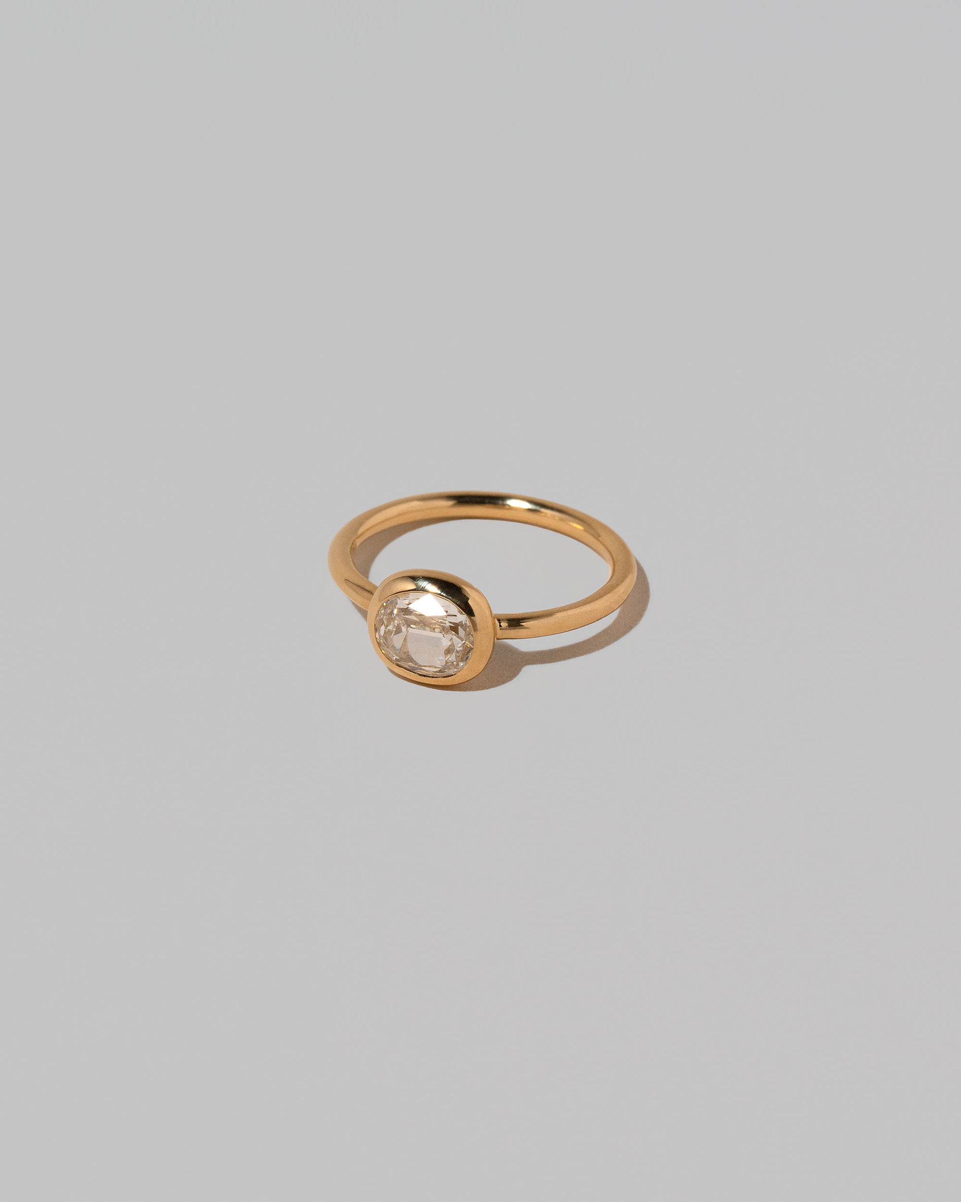 View from the side of the Gusher Diamond Ring 018 on light color background.