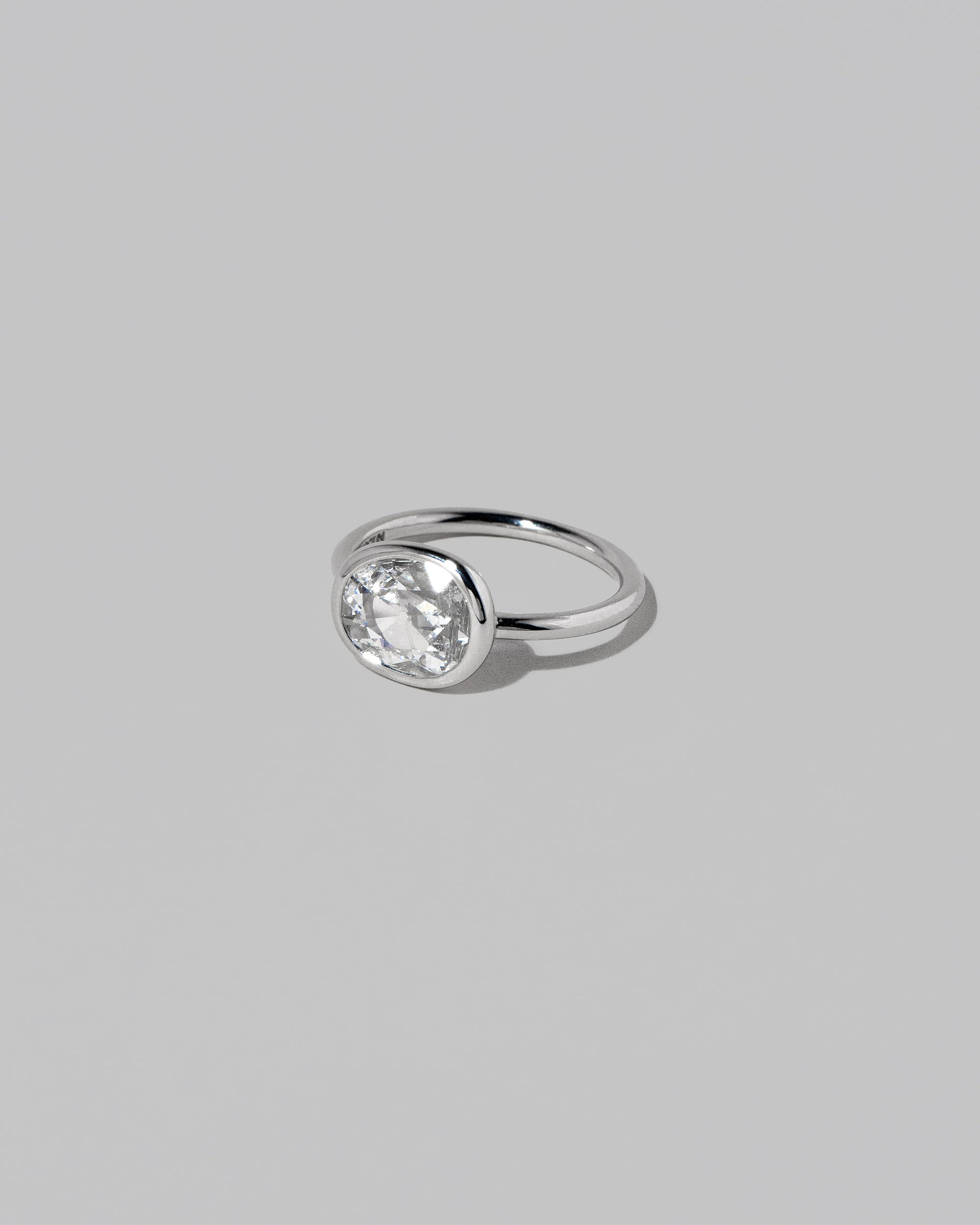 View from the side of the Gusher Diamond Ring 028 on light color background.