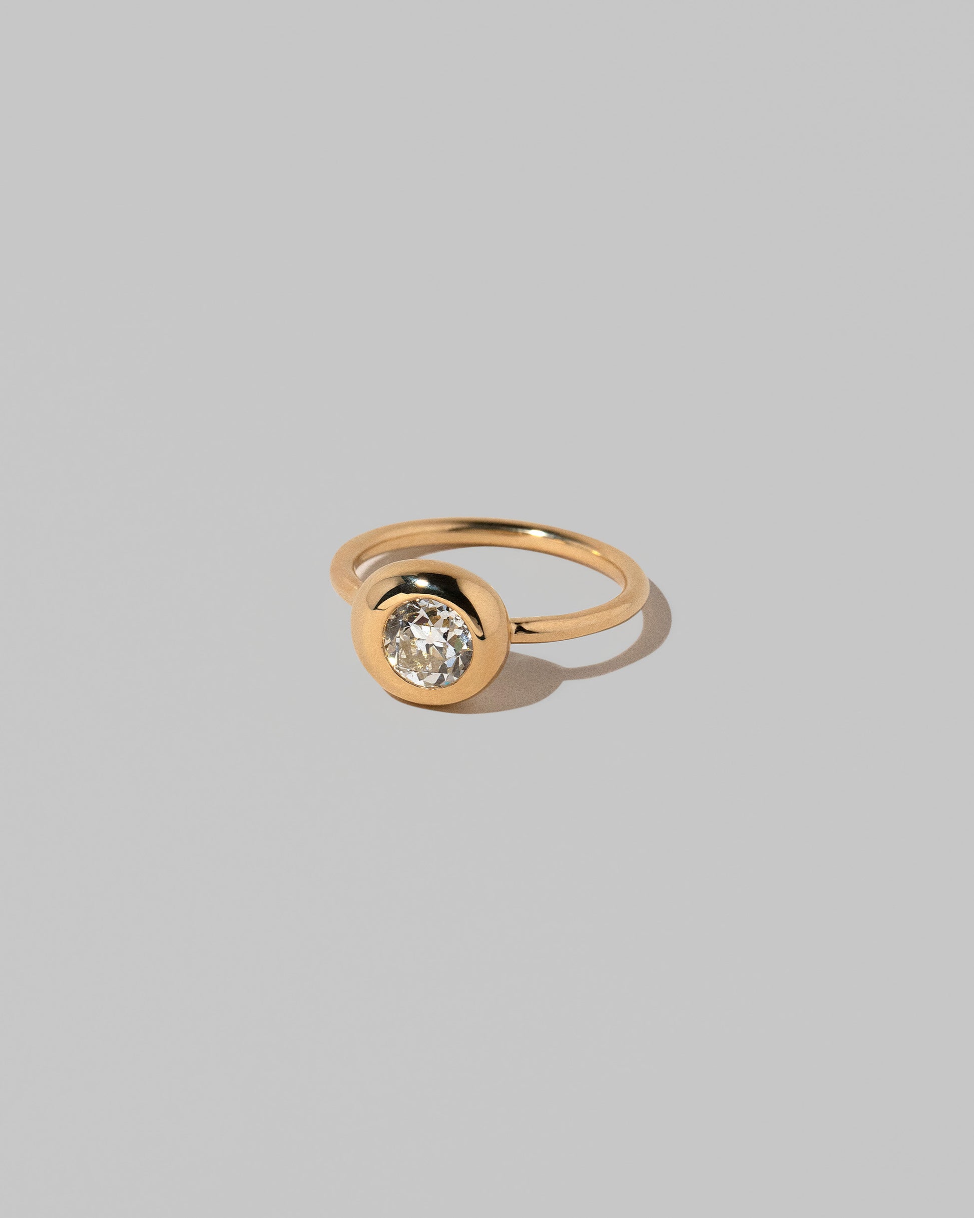 View from the side of the Diamond Grand Level Ring on light color background.