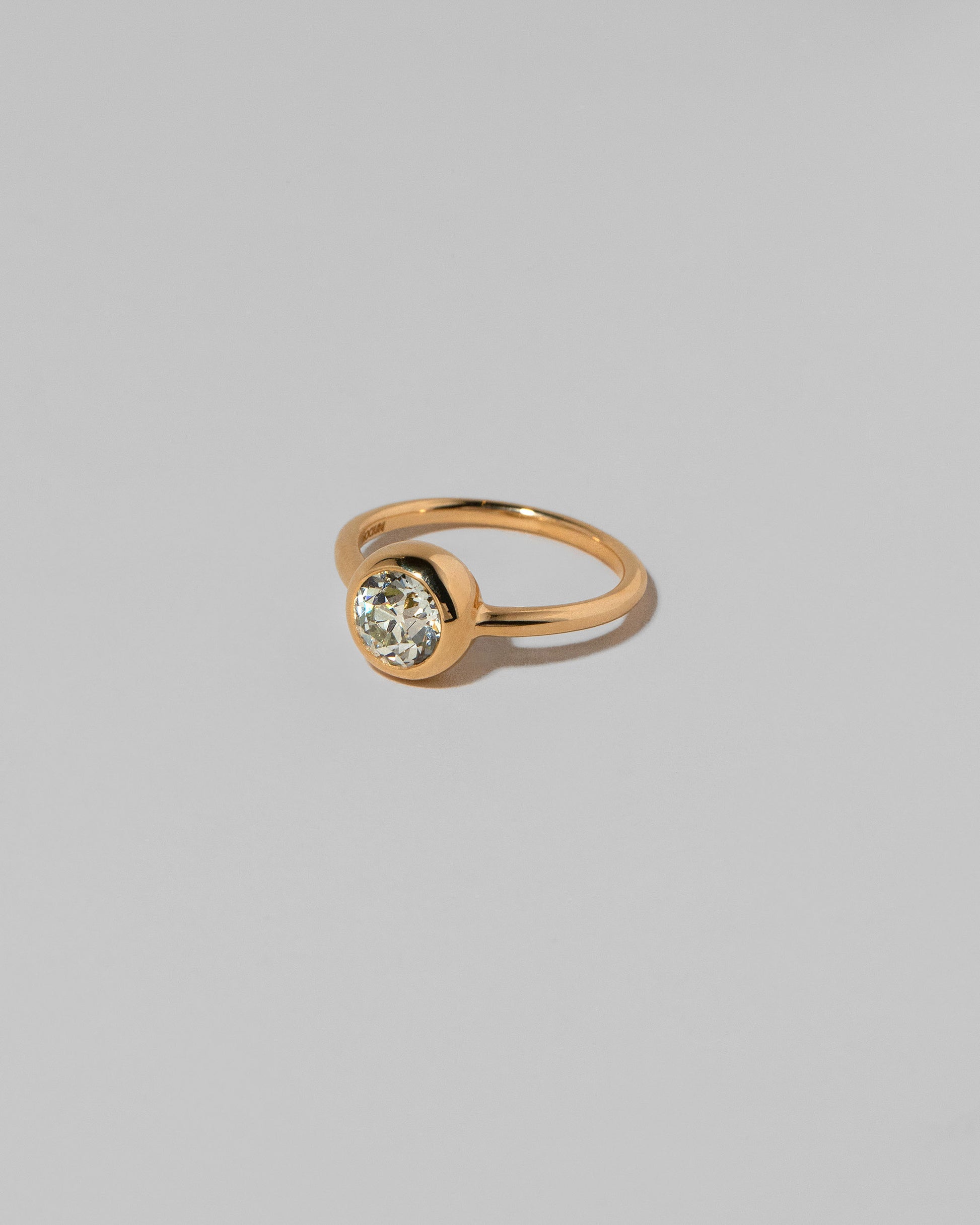 View from the side of the Diamond Wellspring Ring on light color background.