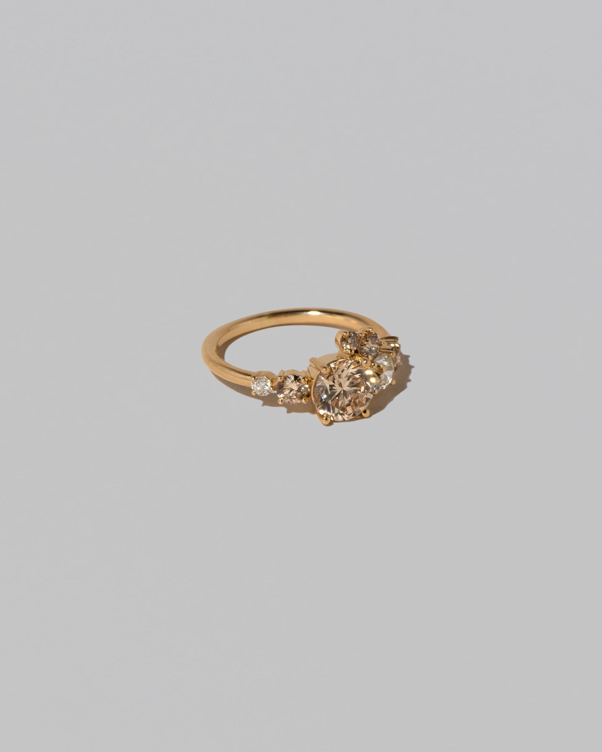 View from the side of the Champagne Diamond Luna Ring on light color background.