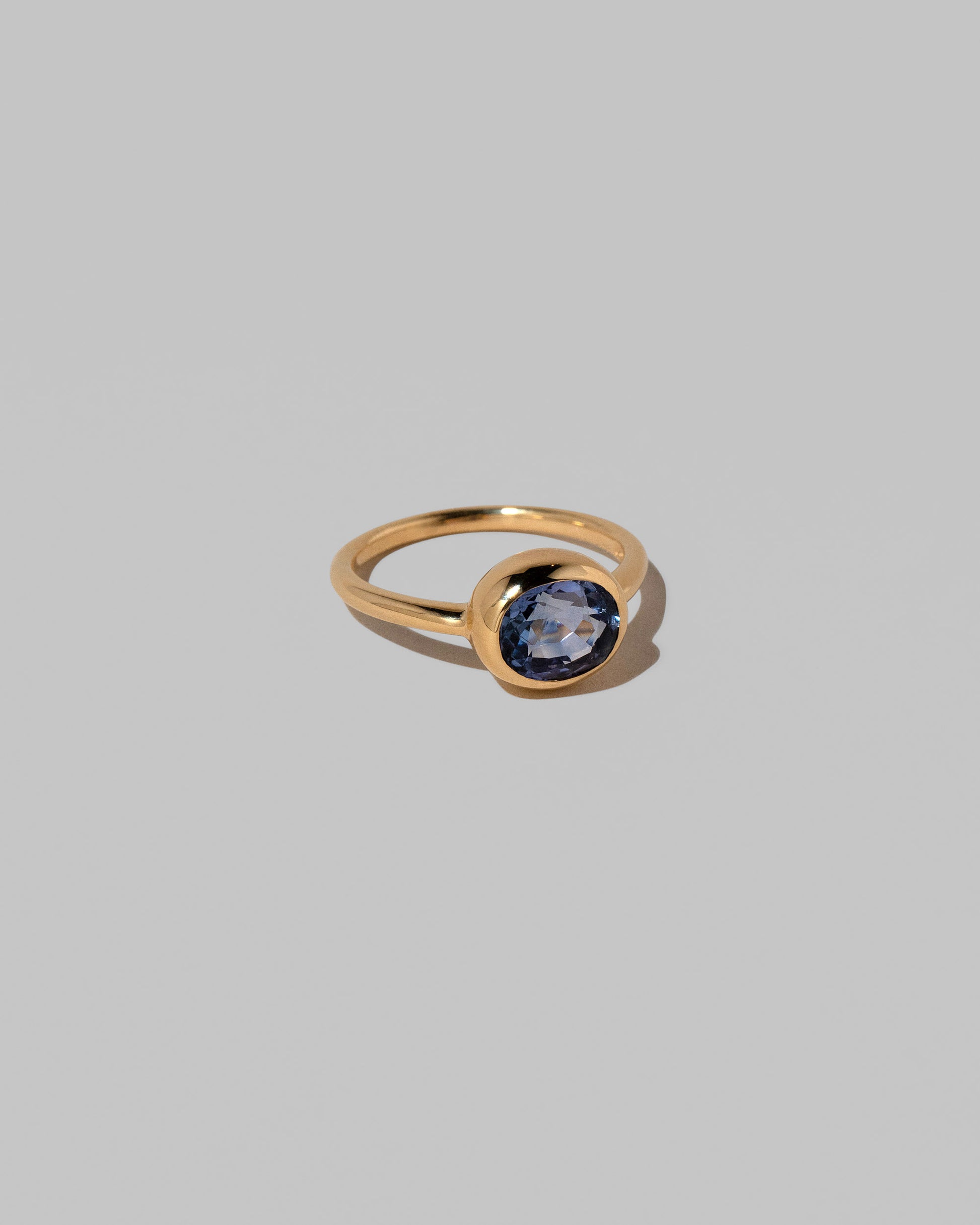 View from the side of the Geyser Blue Sapphire Ring 002 on light color background.