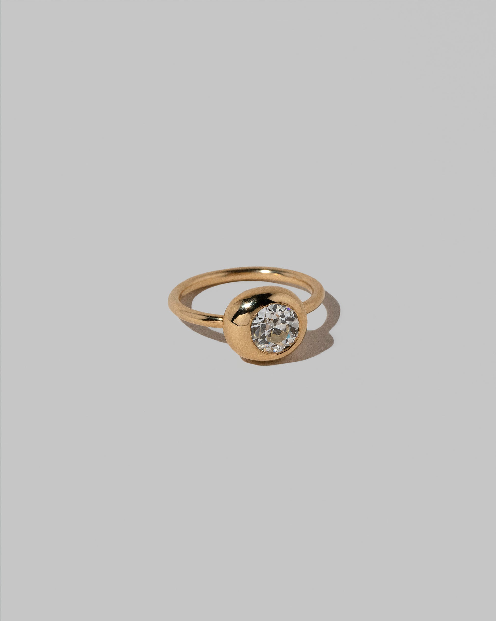 View from the side of the Diamond Level Ring on light color background.