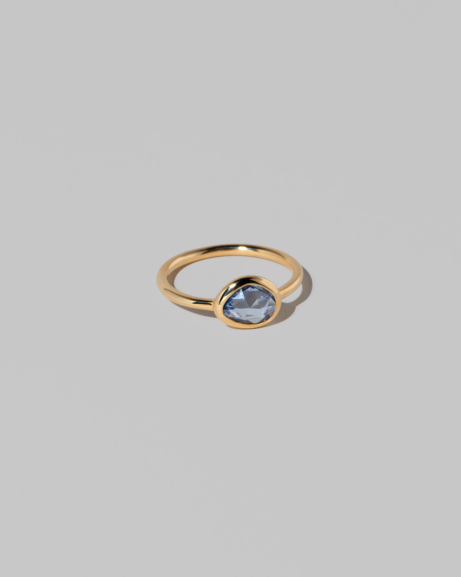 View from the side of the Gusher Blue Sapphire Ring 023 on light color background.