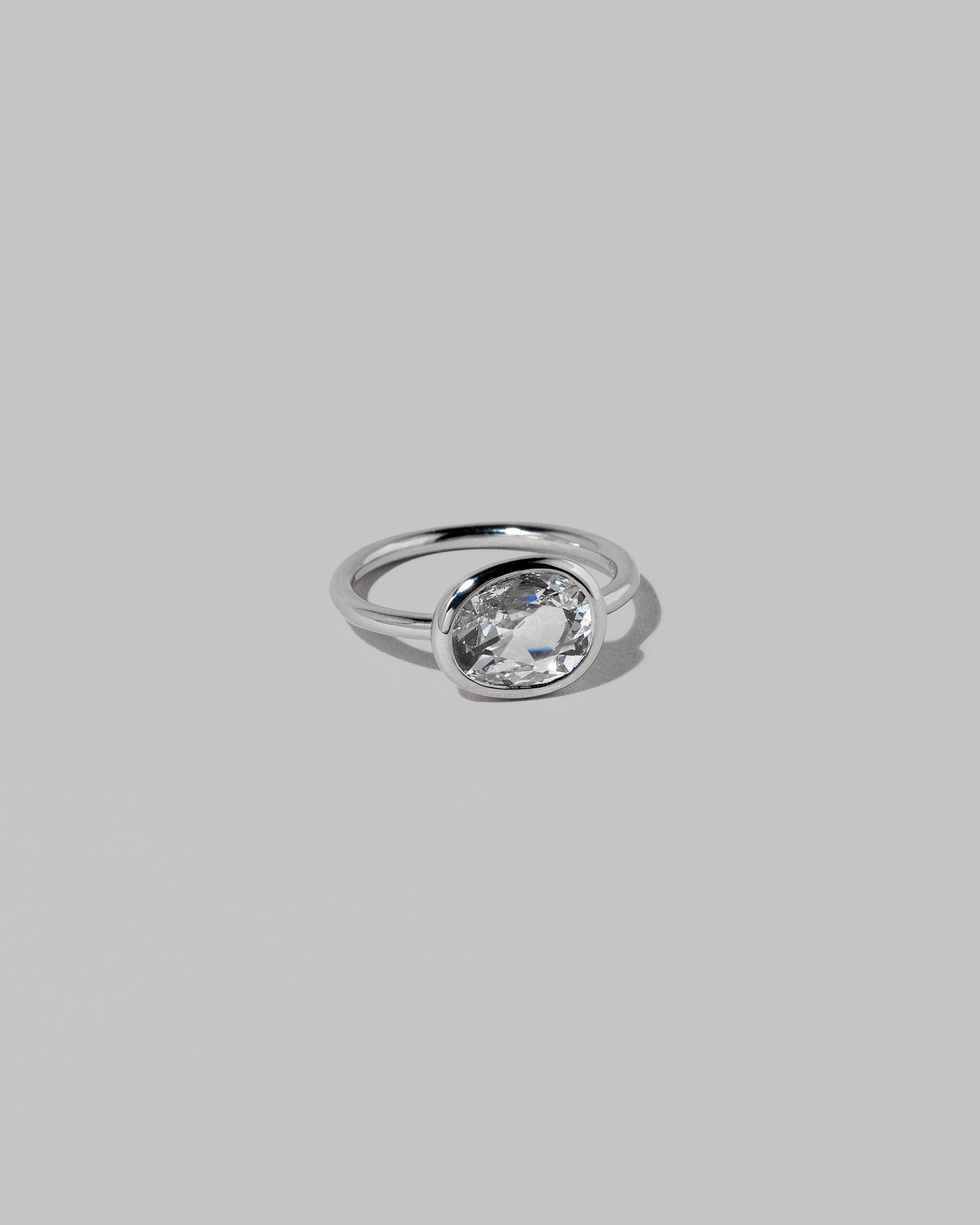 View from the side of the Gusher Diamond Ring 028 on light color background.