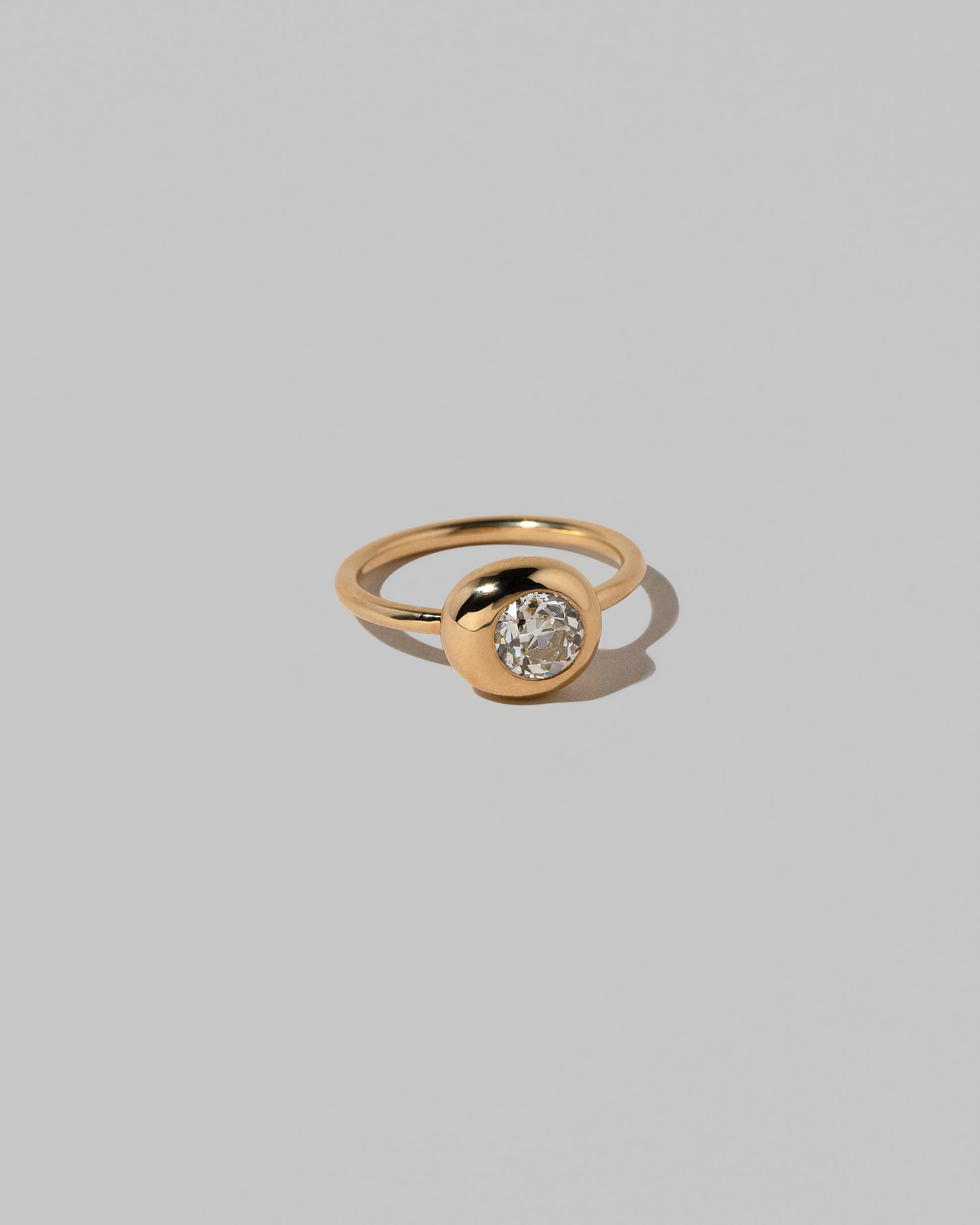View from the side of the Diamond Grand Level Ring on light color background.