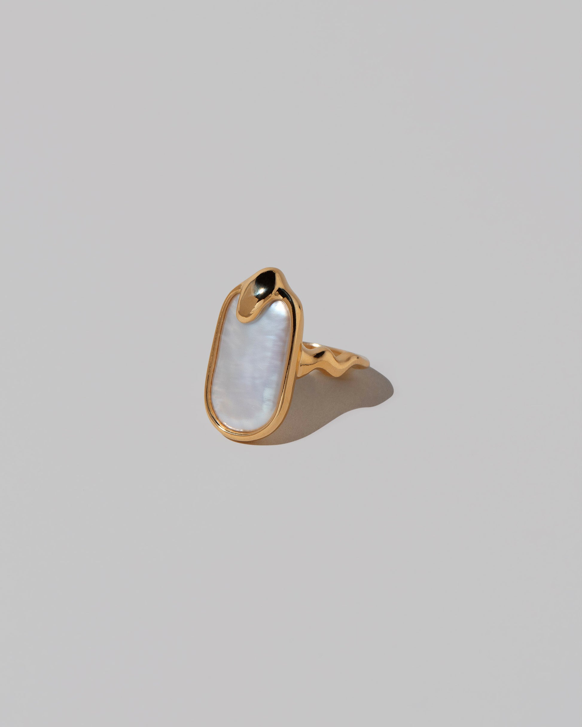 View from the side of the Oceanus Ring on light color background.