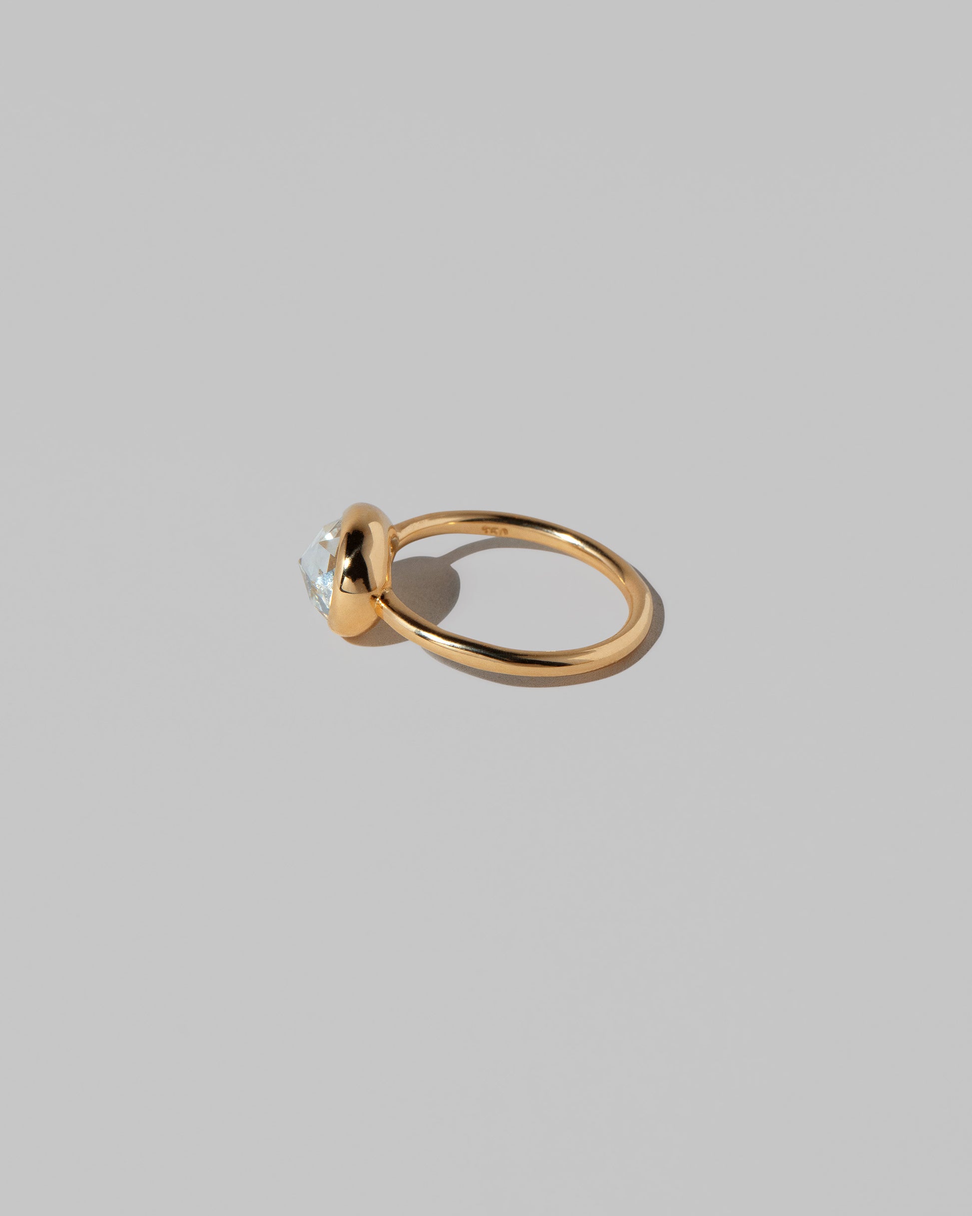 View from the back of the Gusher Diamond Ring 027 on light color background.