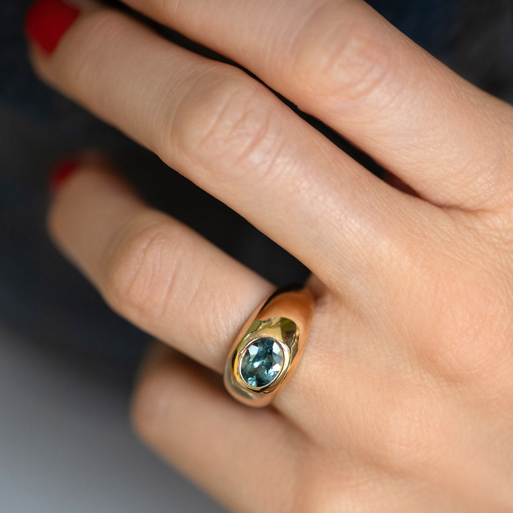 Teal Sapphire Jupiter Ring on model.