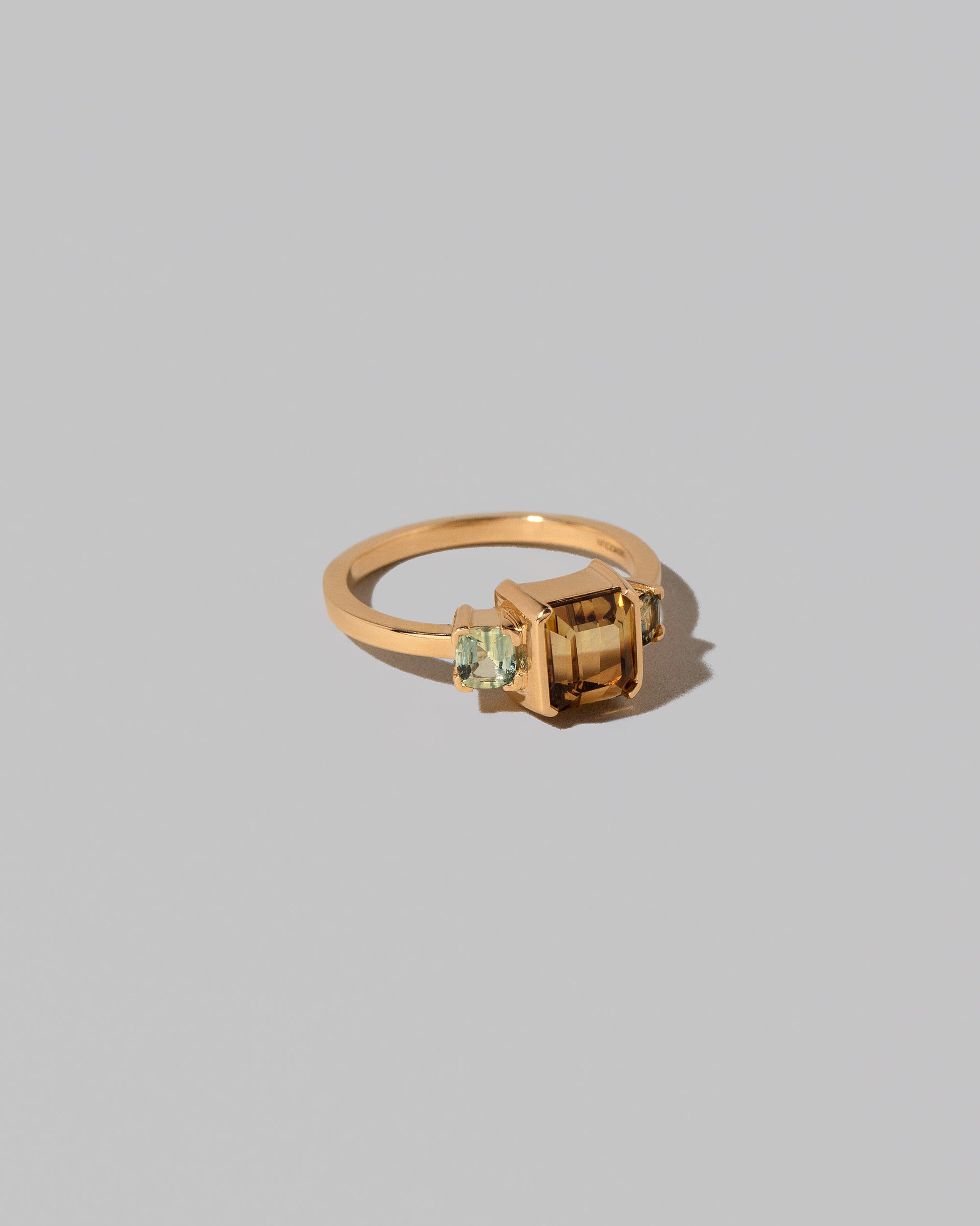 View from the side of the Brassia Ring on light color background.