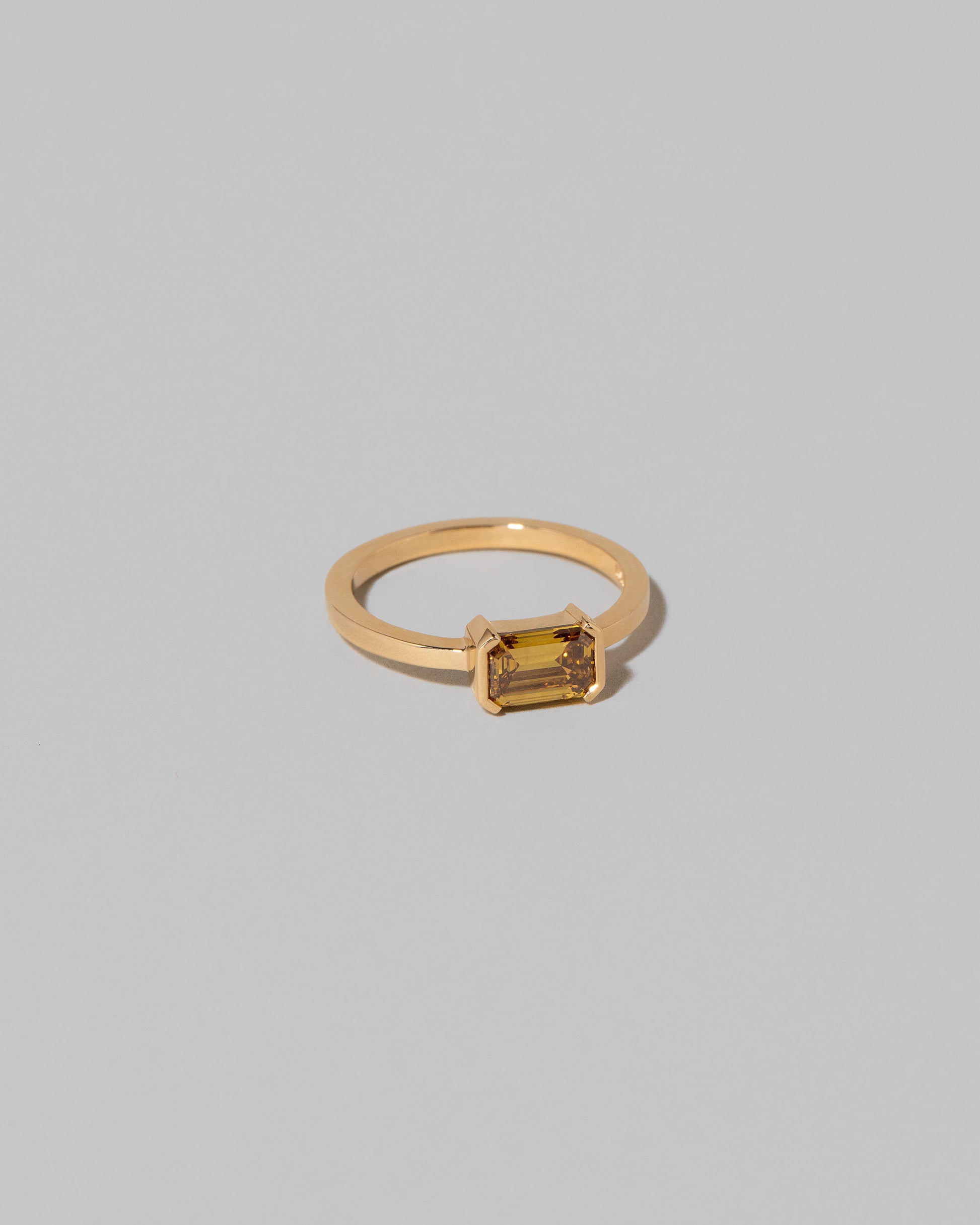 View from the side of the Brown Diamond Courtship Ring on light color background.