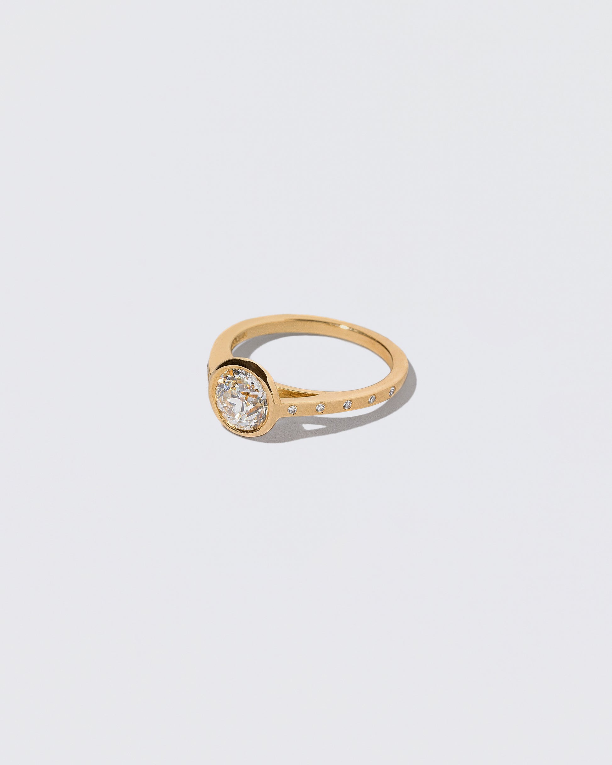 View from the side of the Diamond Calatrava Ring on light color background.