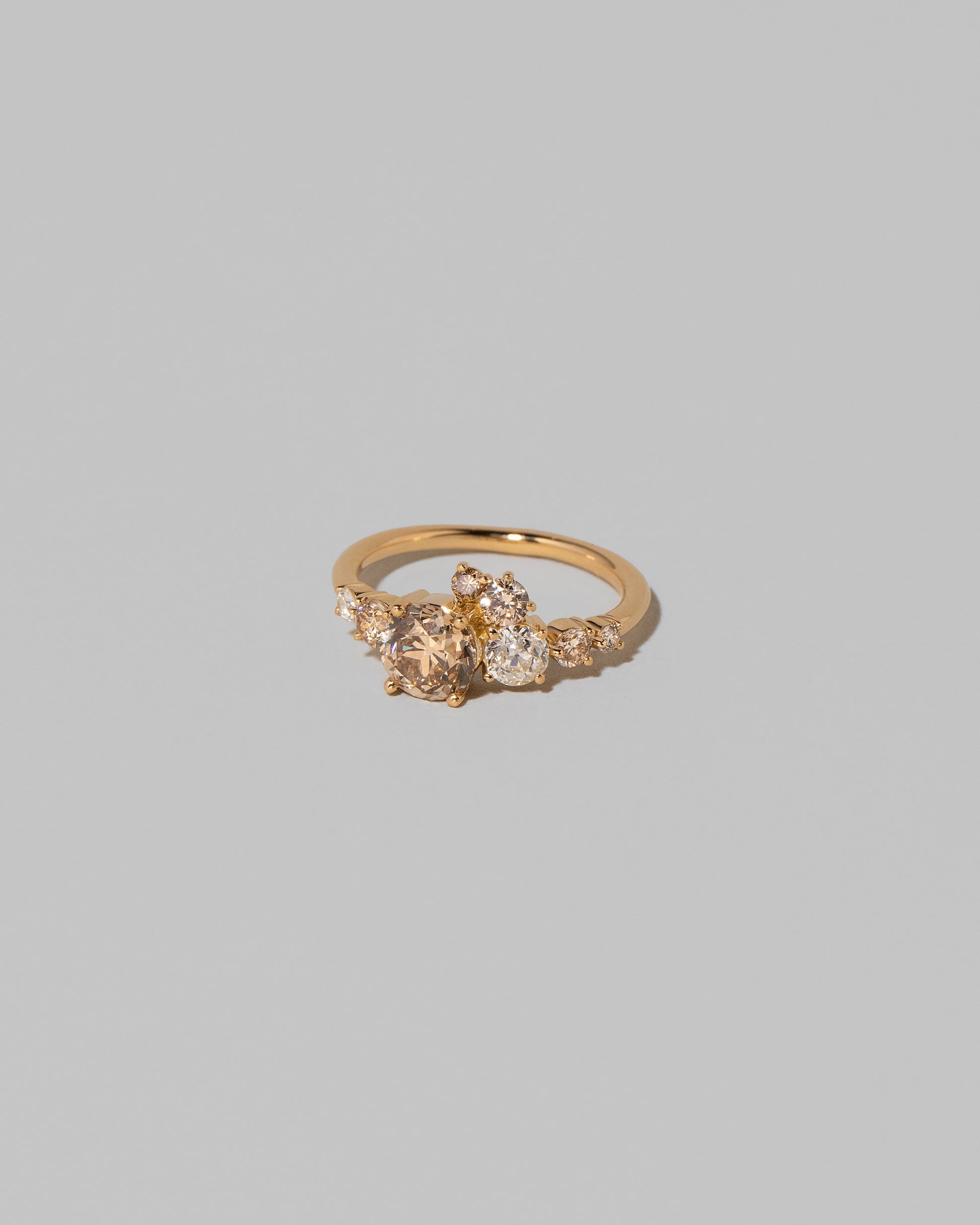 View from the side of the Champagne Diamond Luna Ring on light color background.