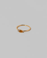 View from the side of the Citrine Teardrops Ring on light color background.