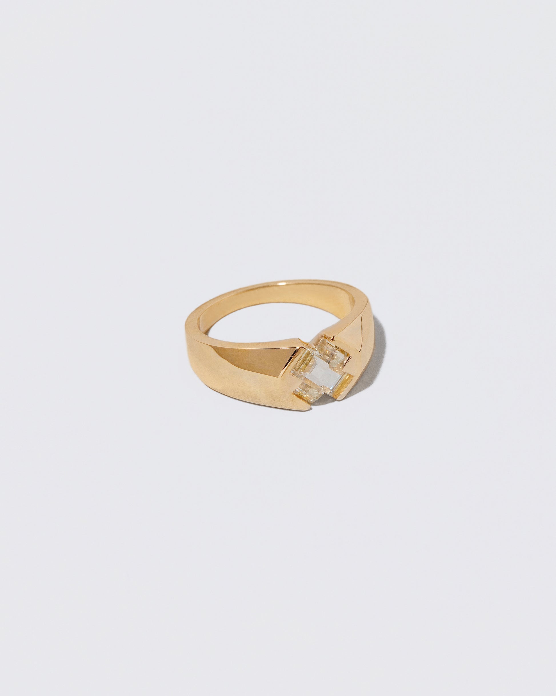 View from the side of the Compassion Ring on light color background.
