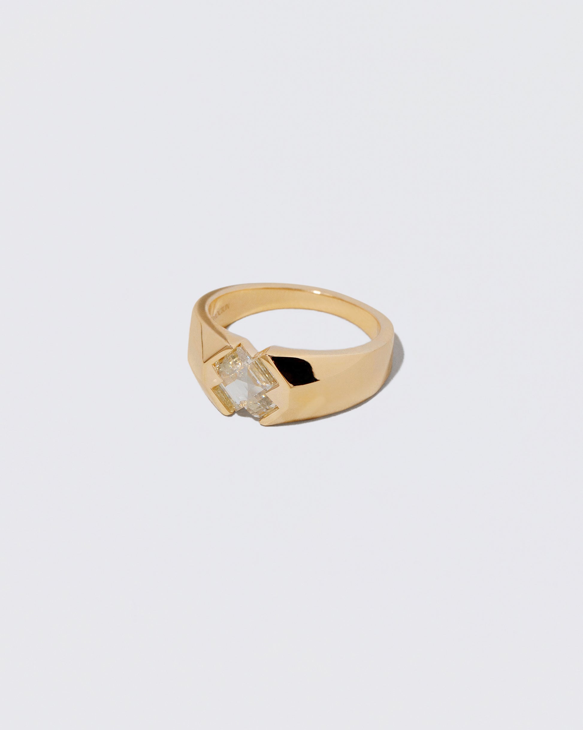 View from the side of the Compassion Ring on light color background.