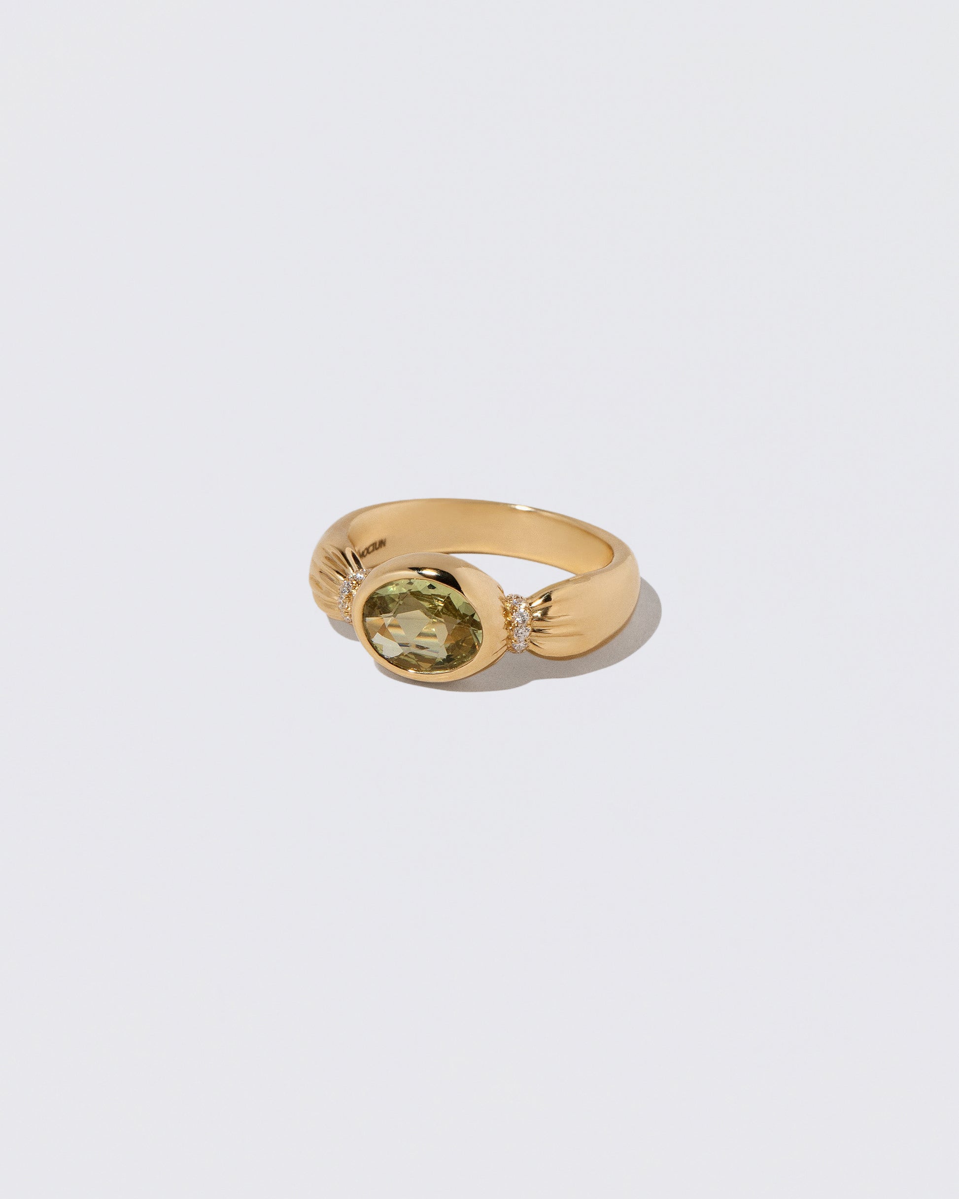 View from the side of the Sapphire Contort Ring on light color background.