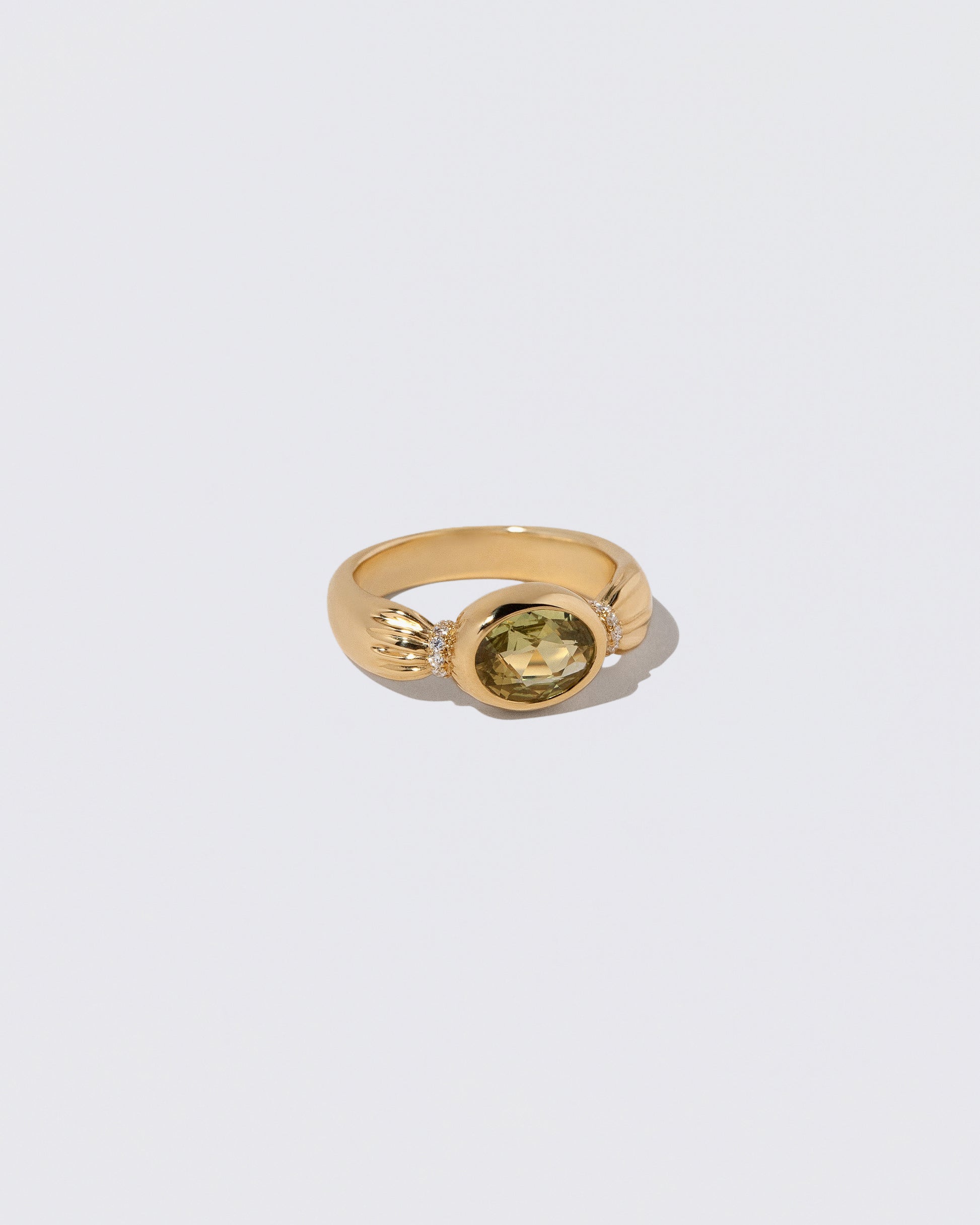View from the side of the Sapphire Contort Ring on light color background.