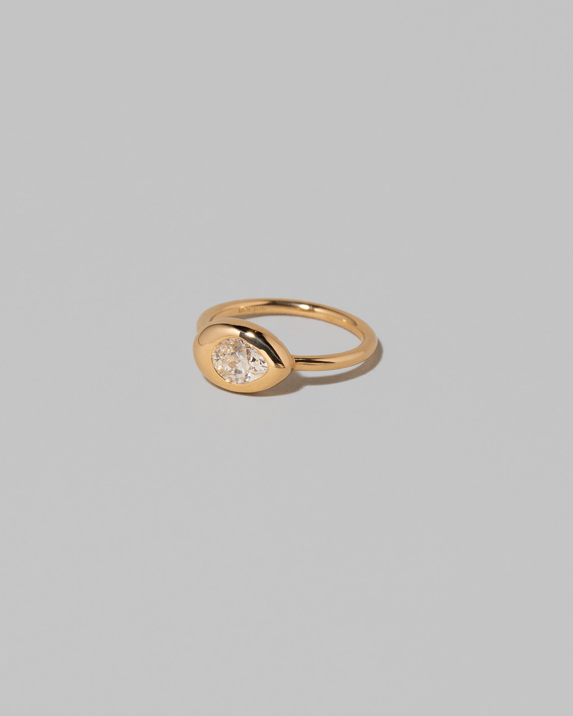 View from the side of the Diamond Align Ring on light color background.