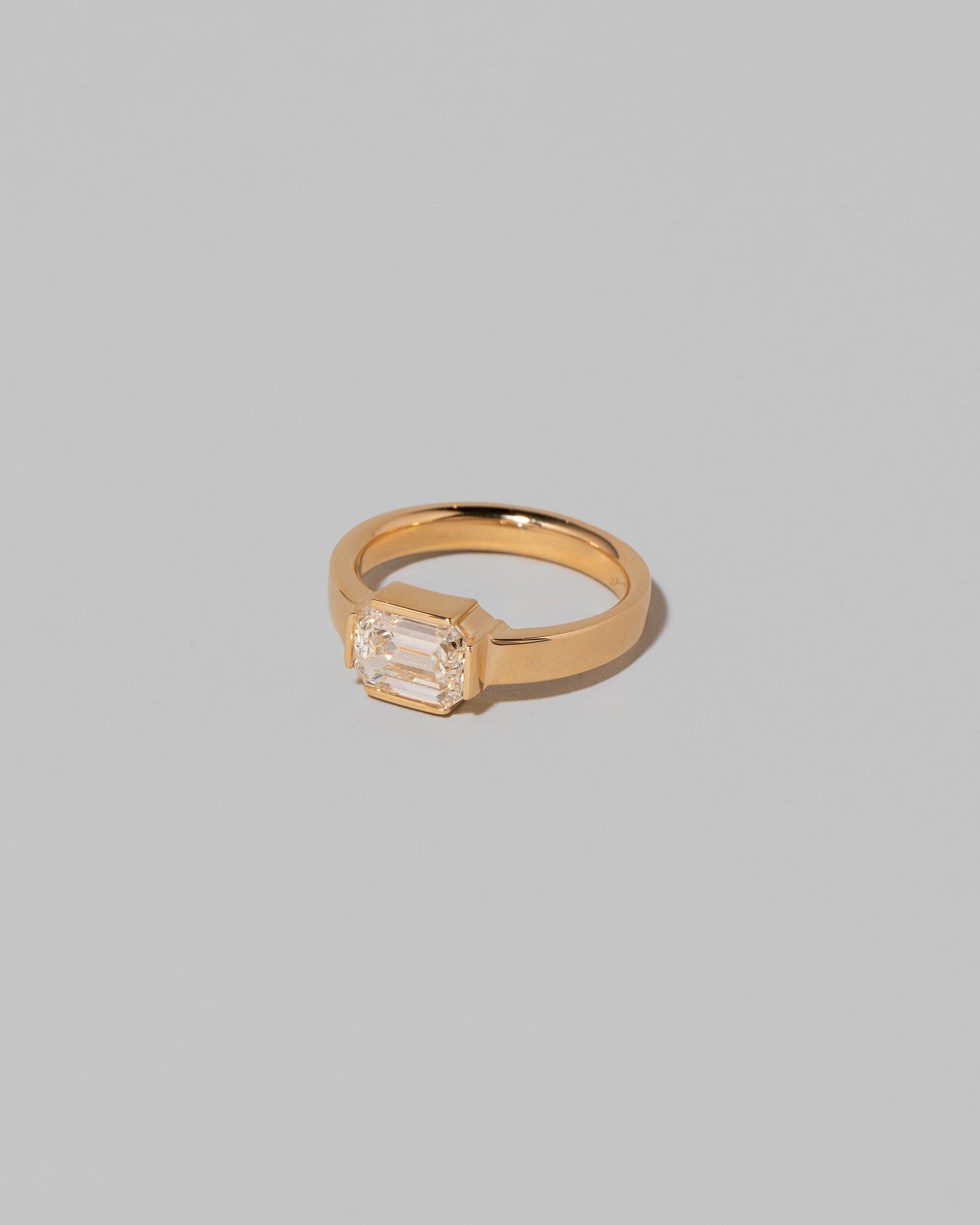 View from the side of the Diamond Fold Ring on light color background.