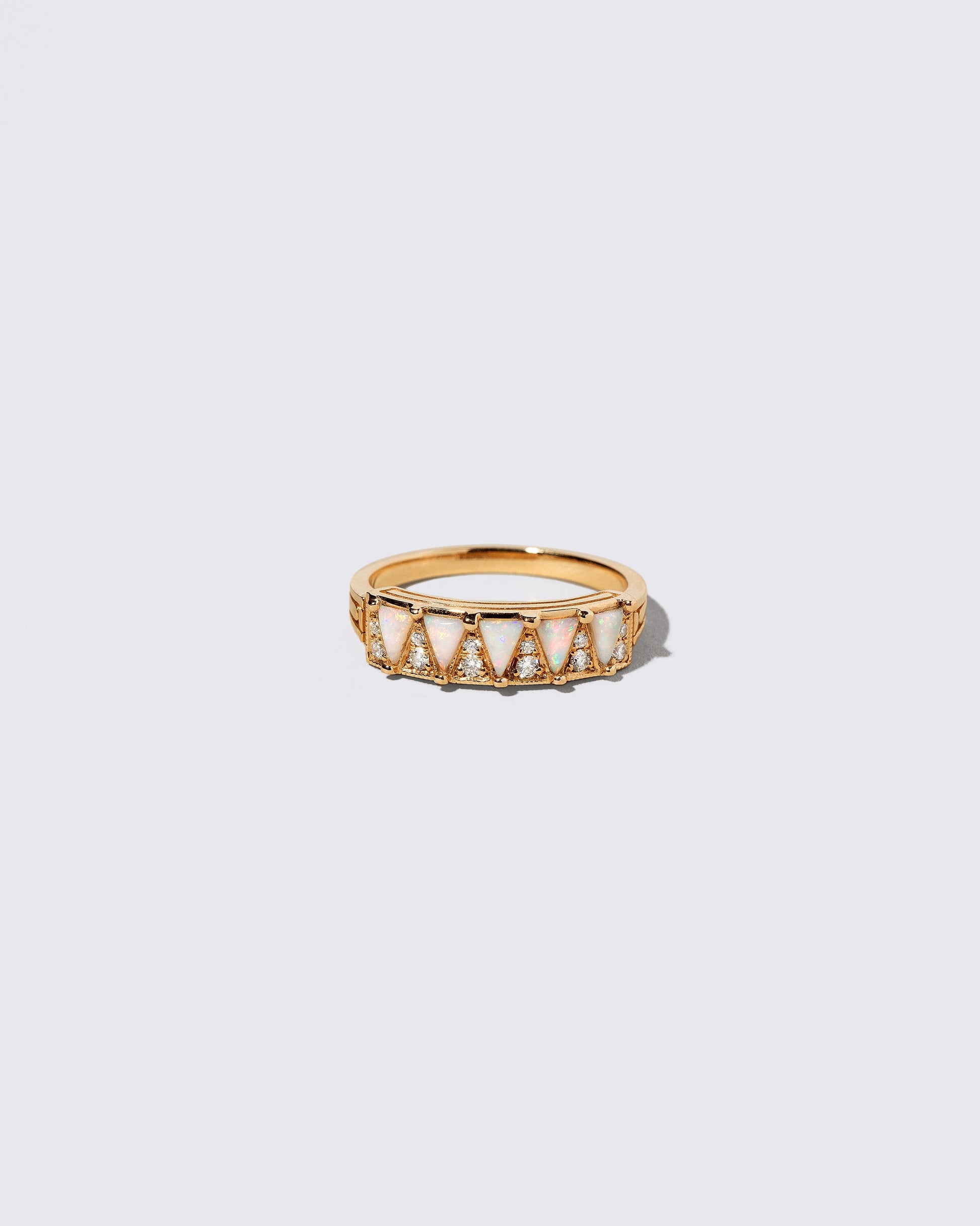 Gold White Opal Five Triangle Ring on light color background.