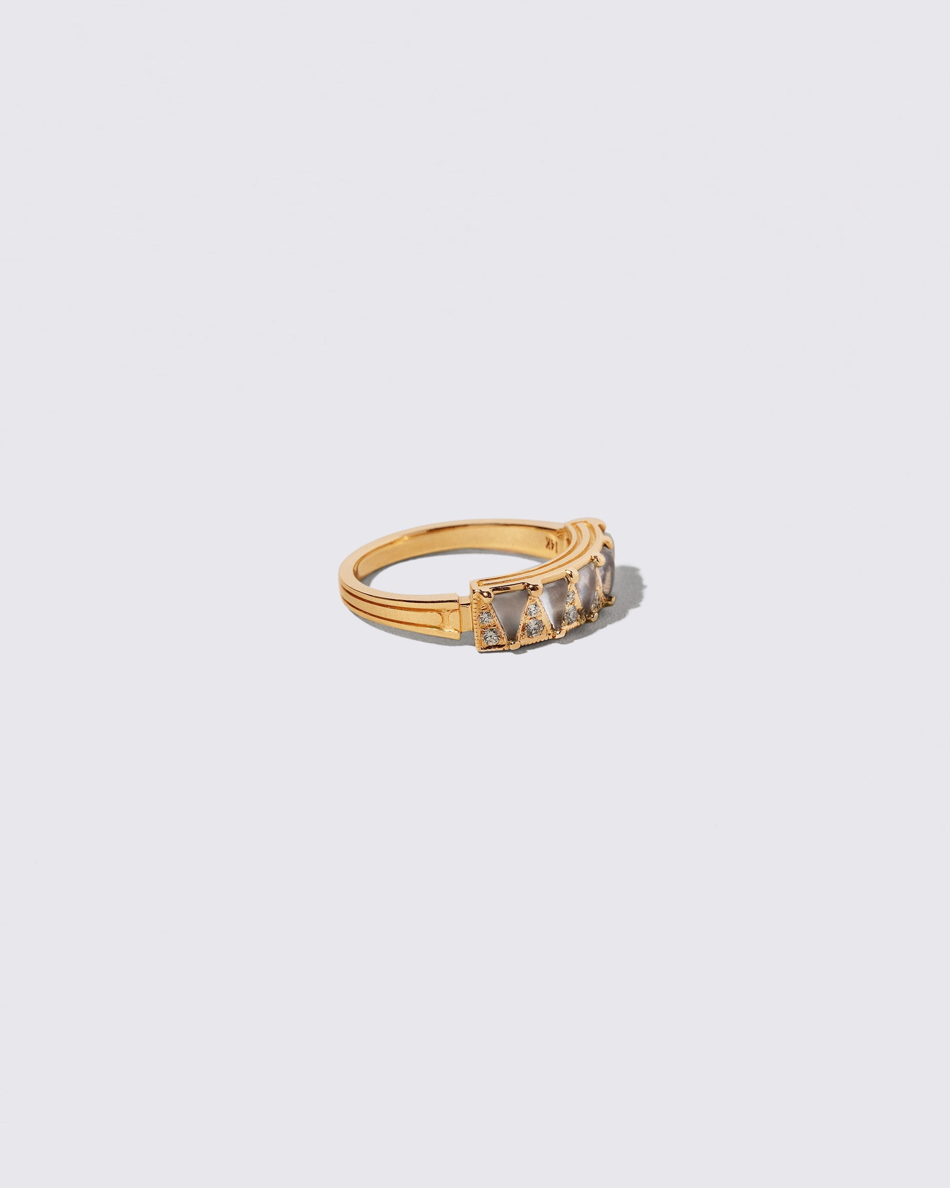 View from the side of the Gold Blue Chalcedony Five Triangle Ring on light color background.