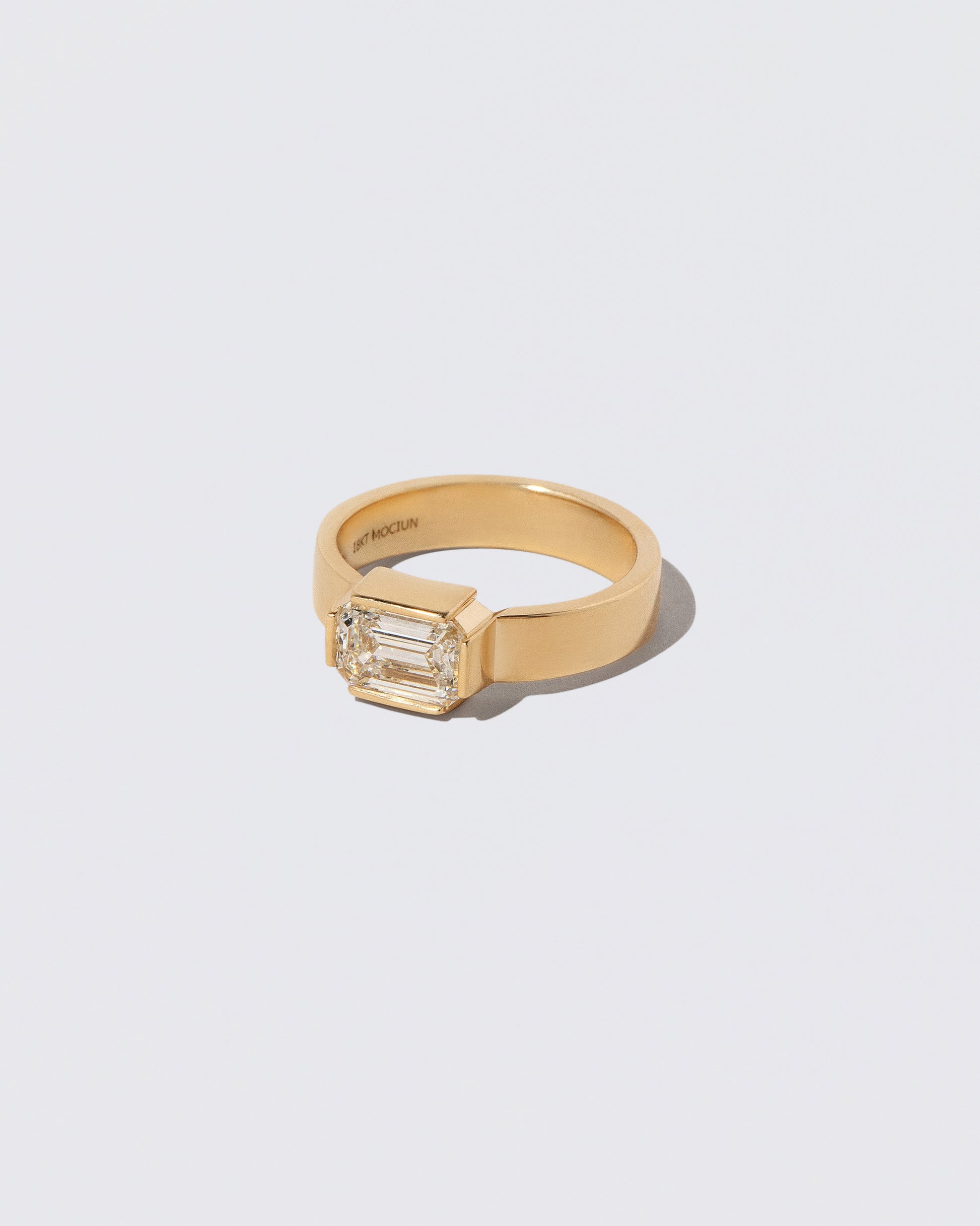 View from the side of the Diamond Fold Ring on light color background.