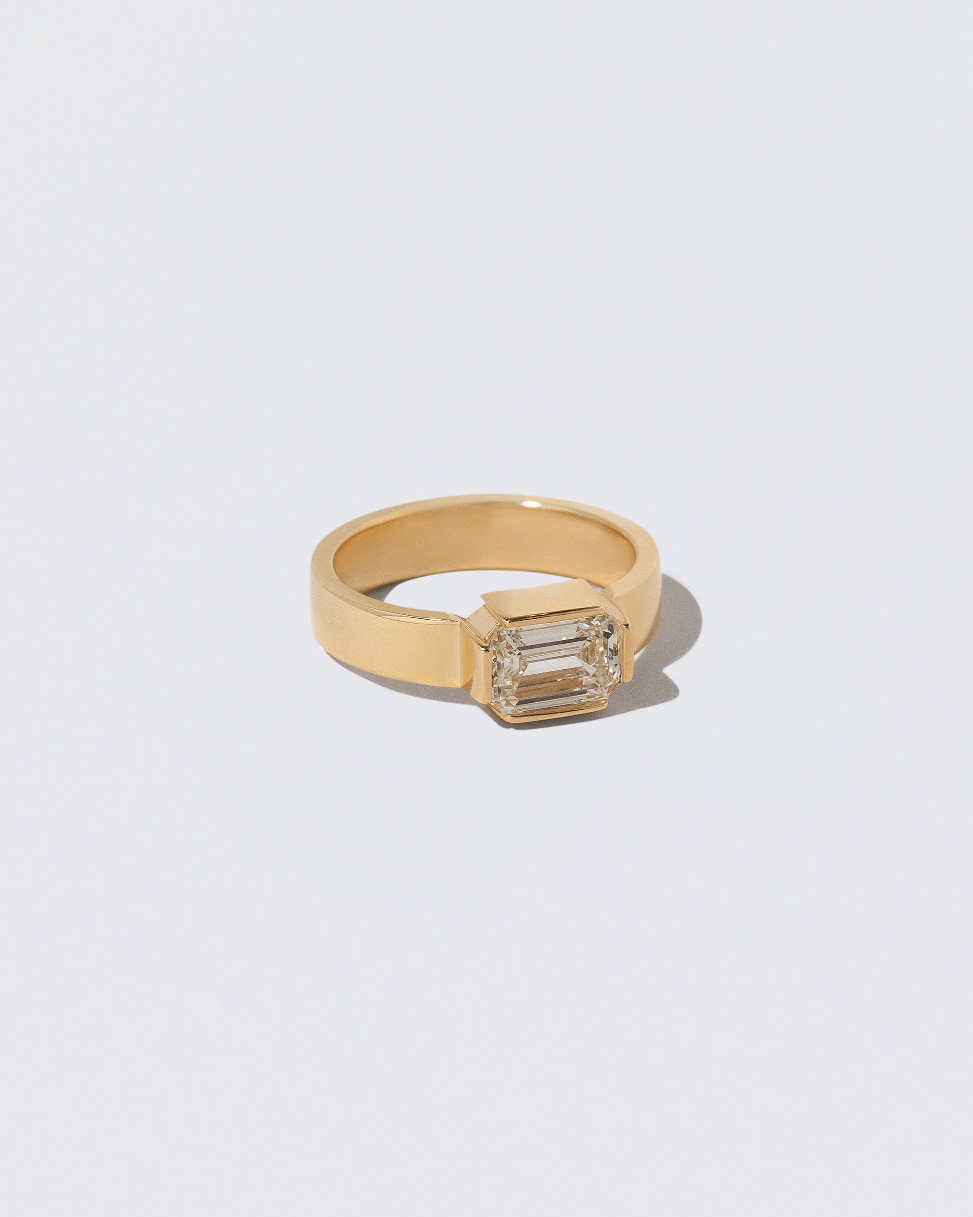 View from the side of the Diamond Fold Ring on light color background.