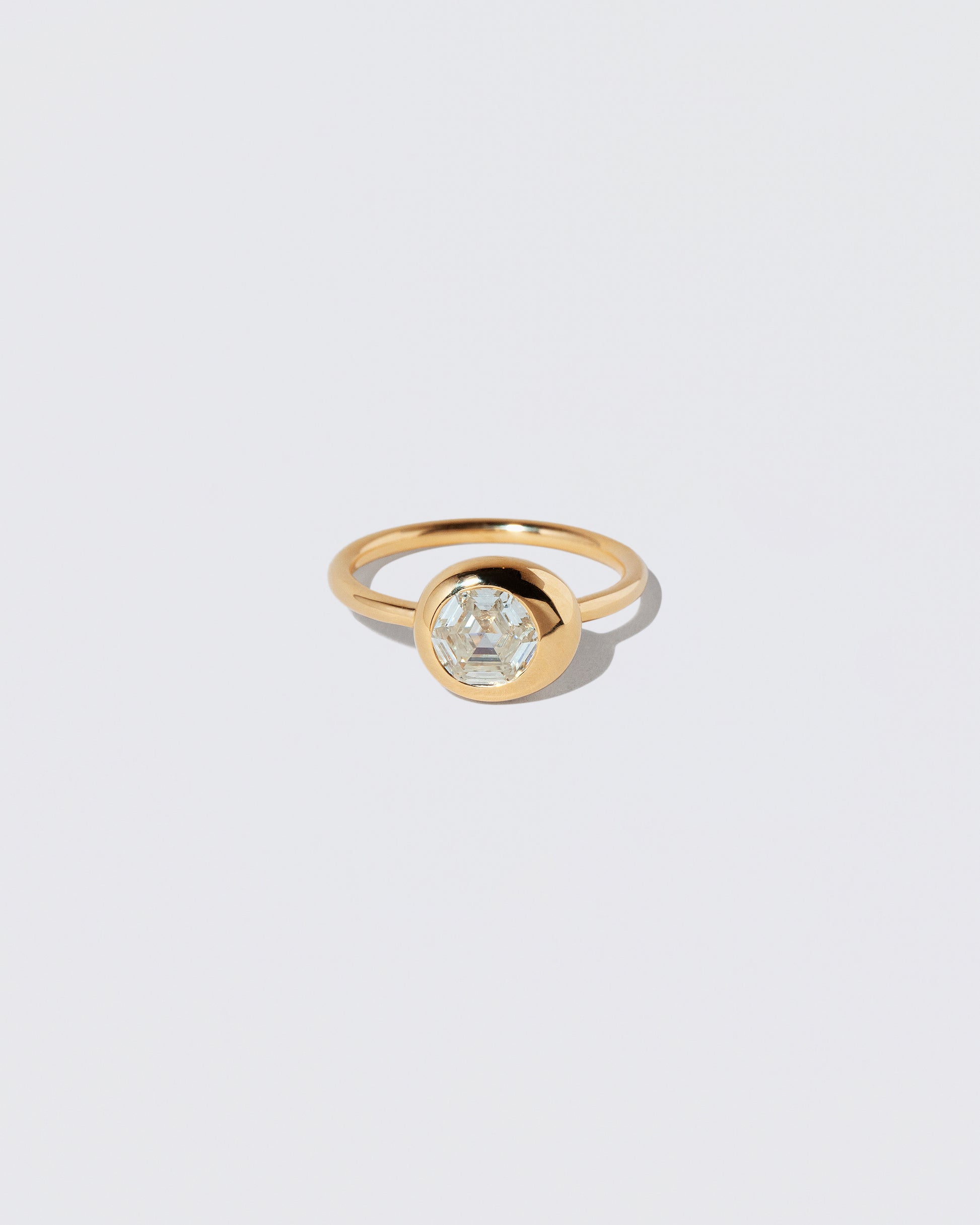 Step Cut Diamond Grand Level Ring on light color background.