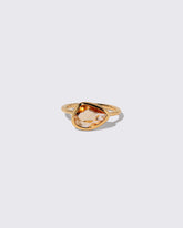 Peach Pink Sapphire Gusher Ring on light color background.