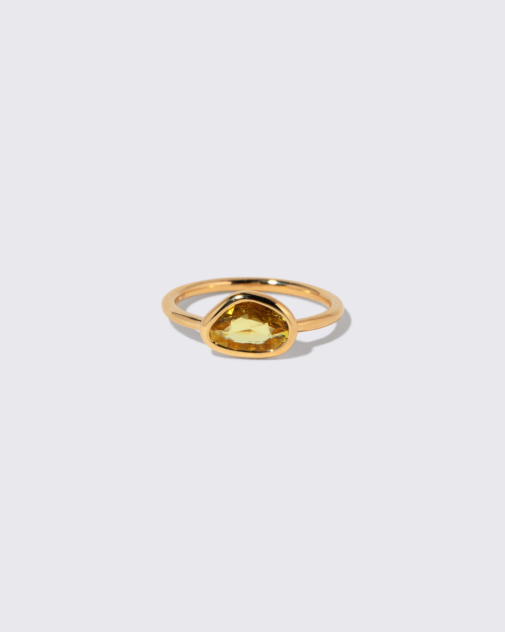Yellow Sapphire Gusher Ring on light color background.