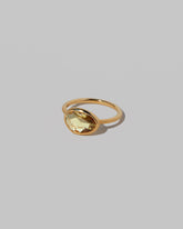 View from the side of the Gusher Yellow Sapphire Ring 033 on light color background.