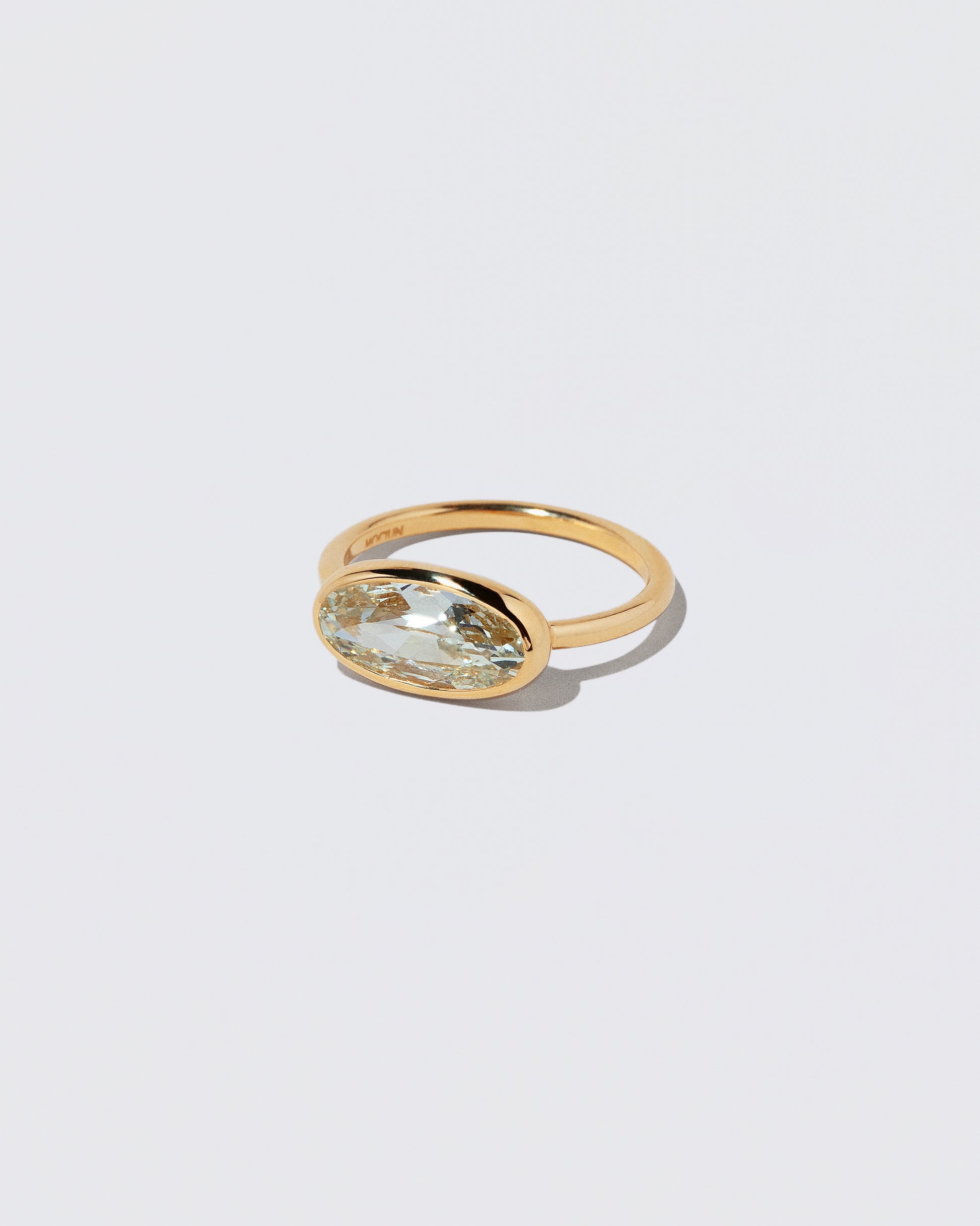 View from the side of the Gusher Diamond Ring 045 on light color background.