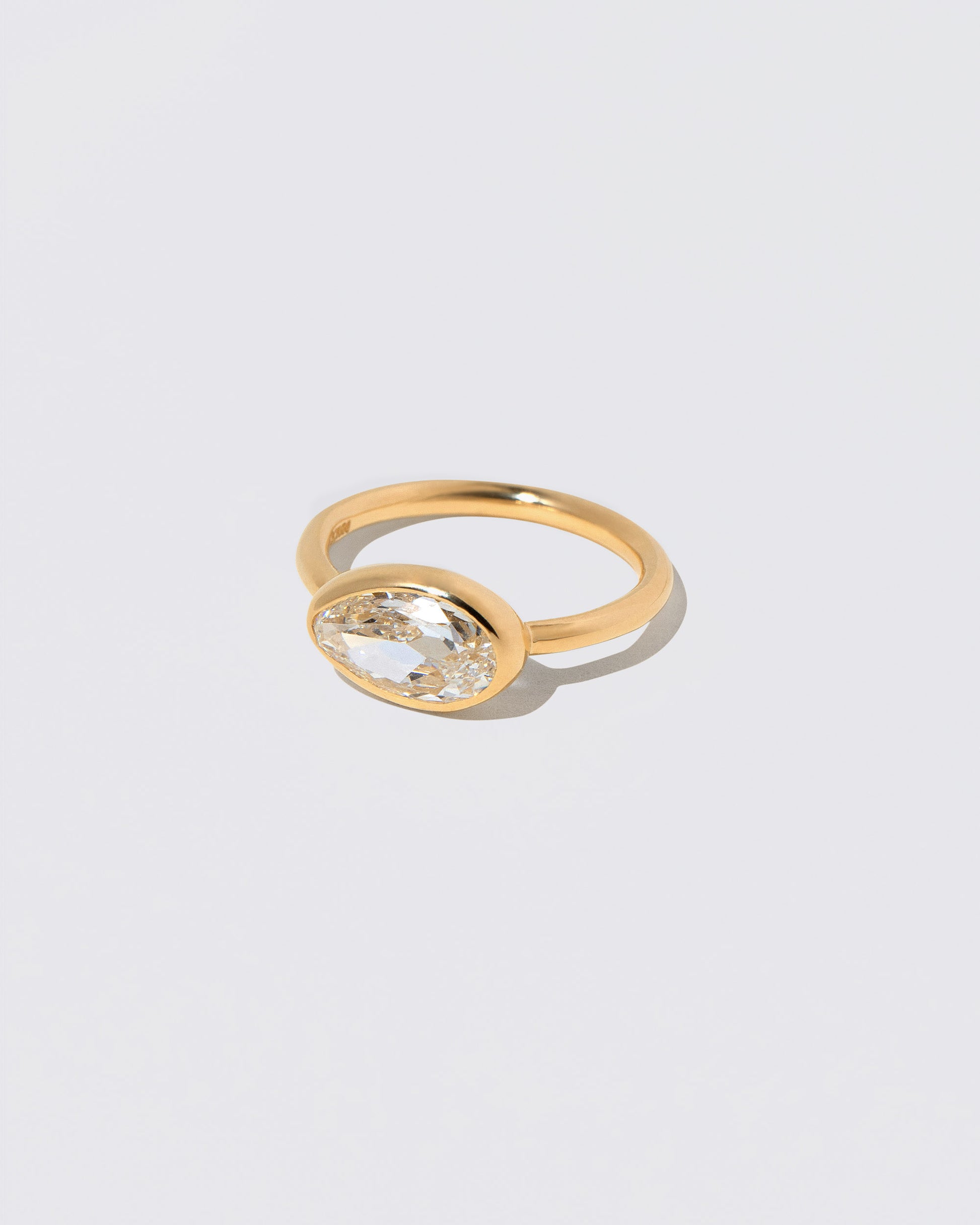 View from the side of the Gusher Diamond Ring 046 on light color background.