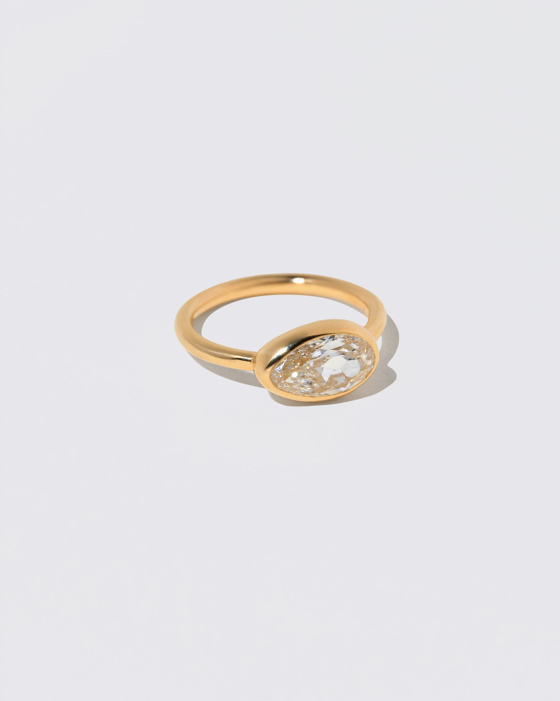 View from the side of the Gusher Diamond Ring 046 on light color background.