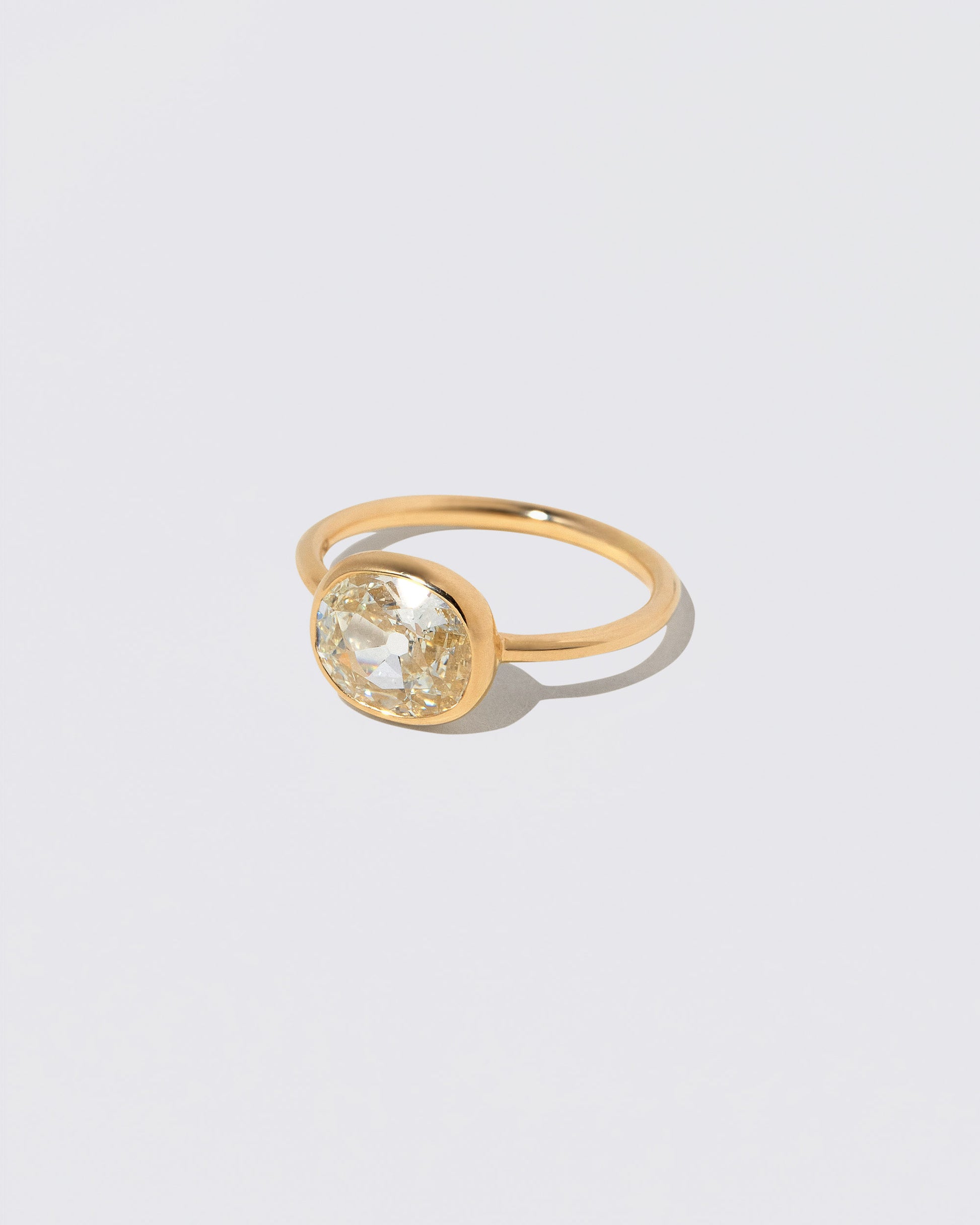 View from the side of the Gusher Diamond Ring 047 on light color background.