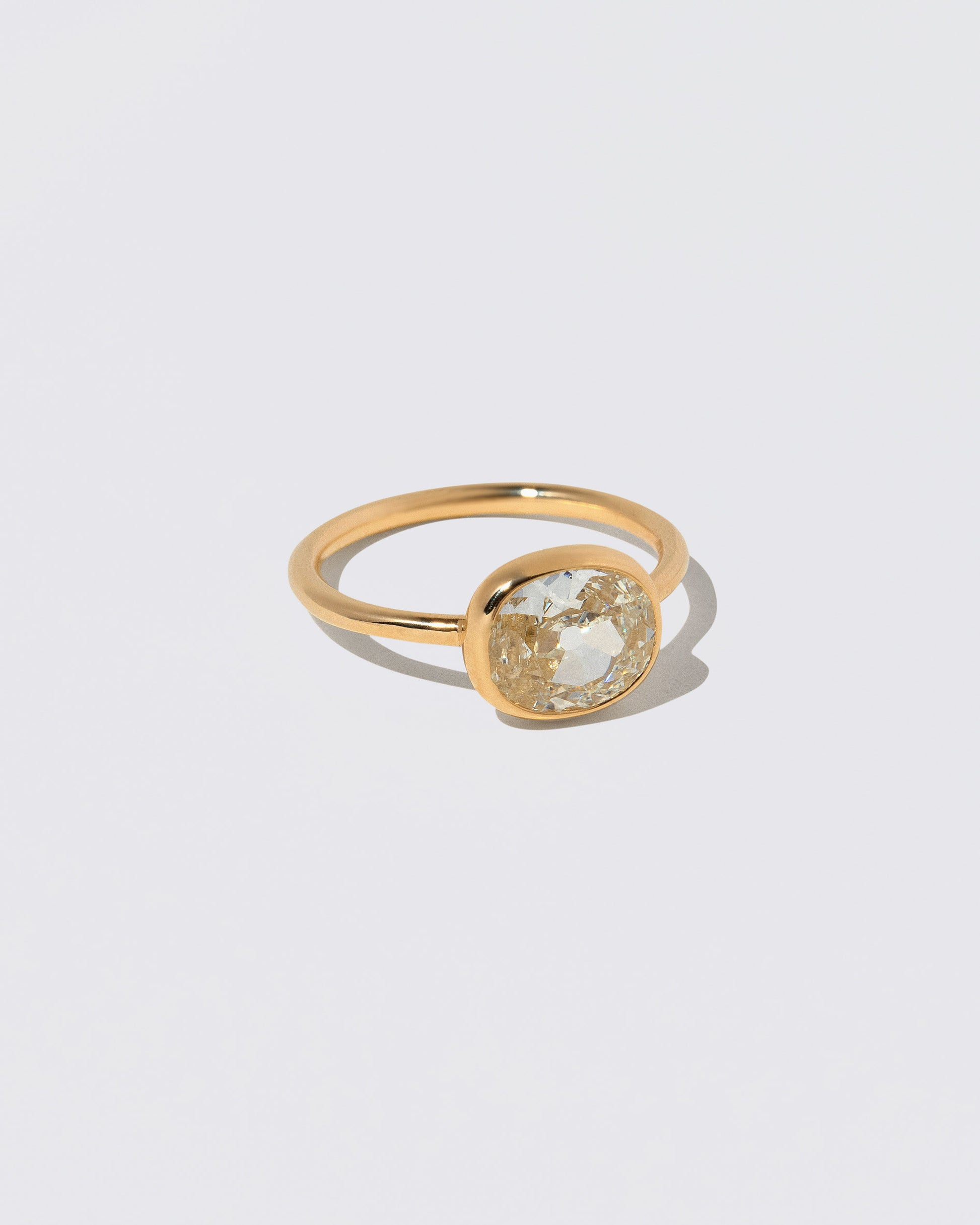 View from the side of the Gusher Diamond Ring 047 on light color background.