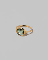 View from the side of the Gusher Green Sapphire Ring 032 on light color background.