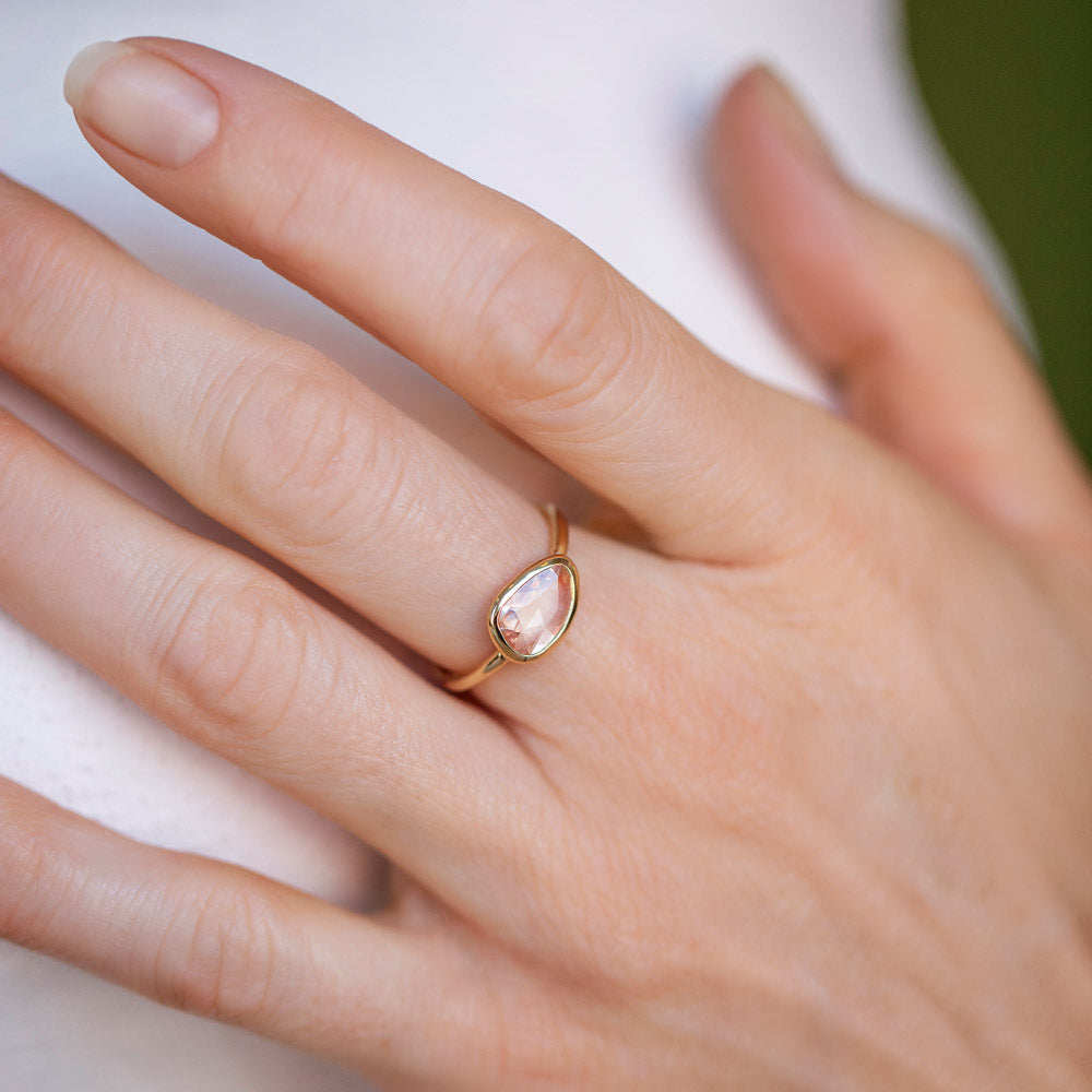 product_details::Gusher Peach Sapphire Ring 051 on model.
