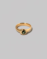 Green Sapphire Level Ring on light color background.