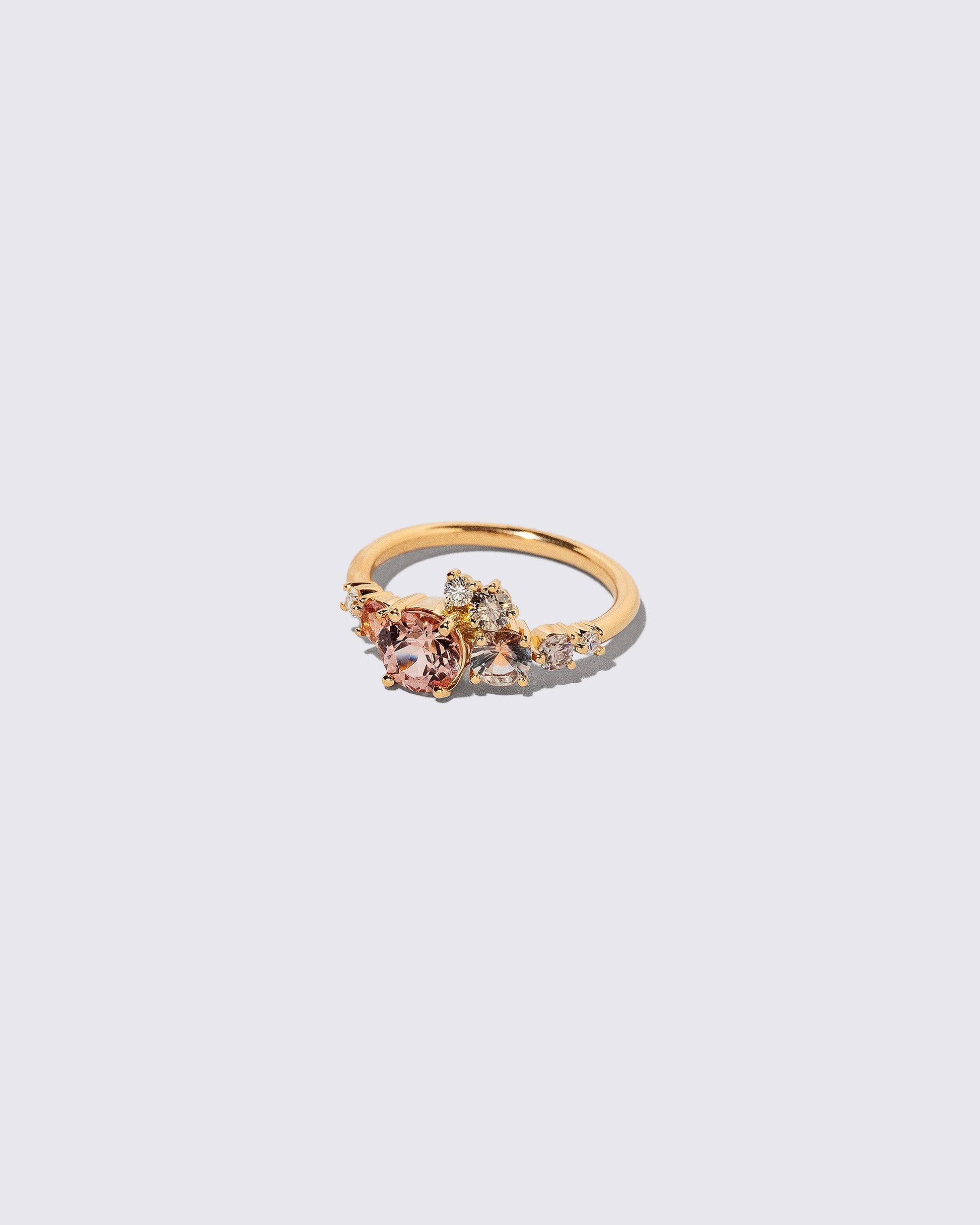 View from the side of the Lotus Garnet Luna Ring on light color background.