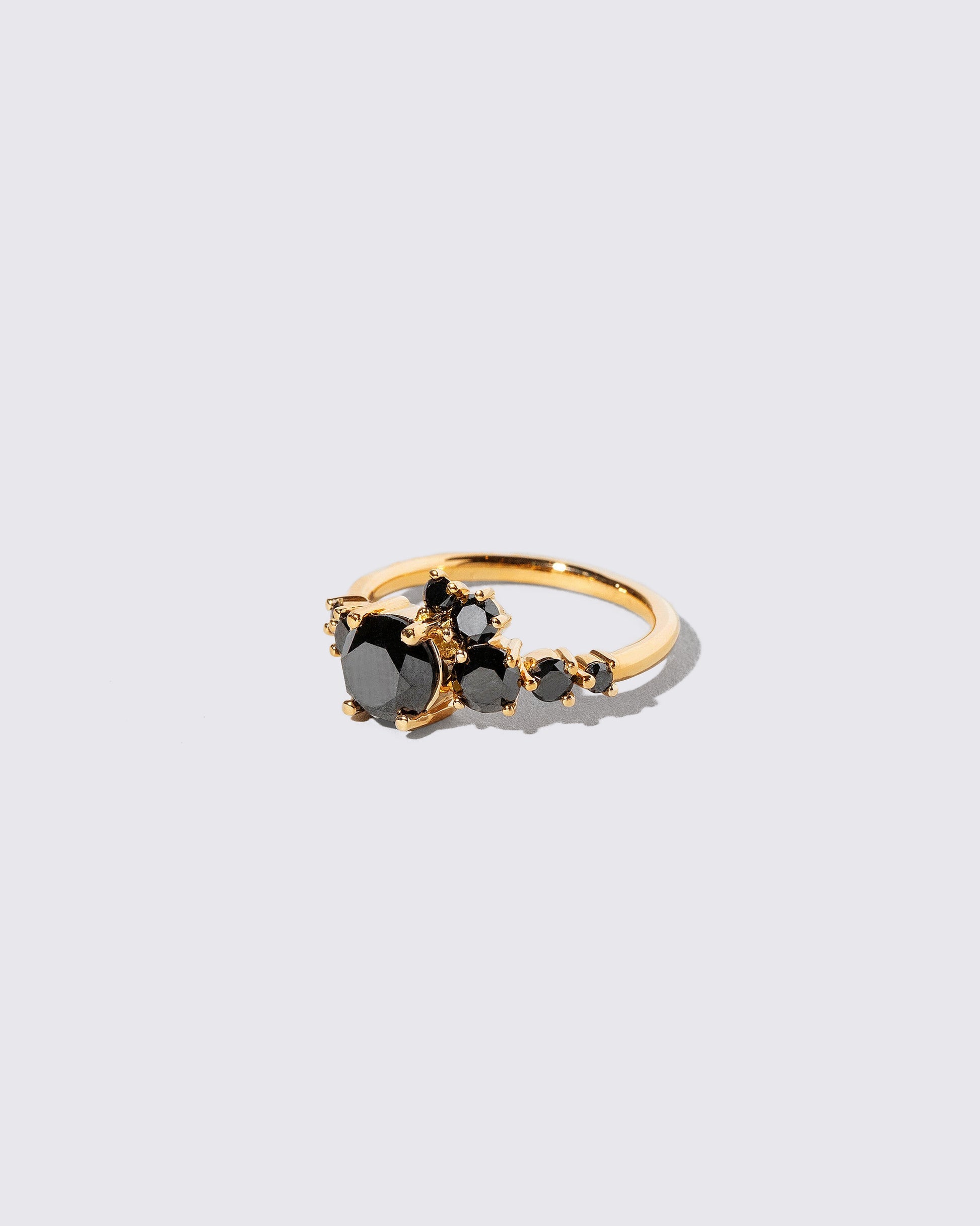 View from the side of the All Black Diamond Luna Ring on light color background.