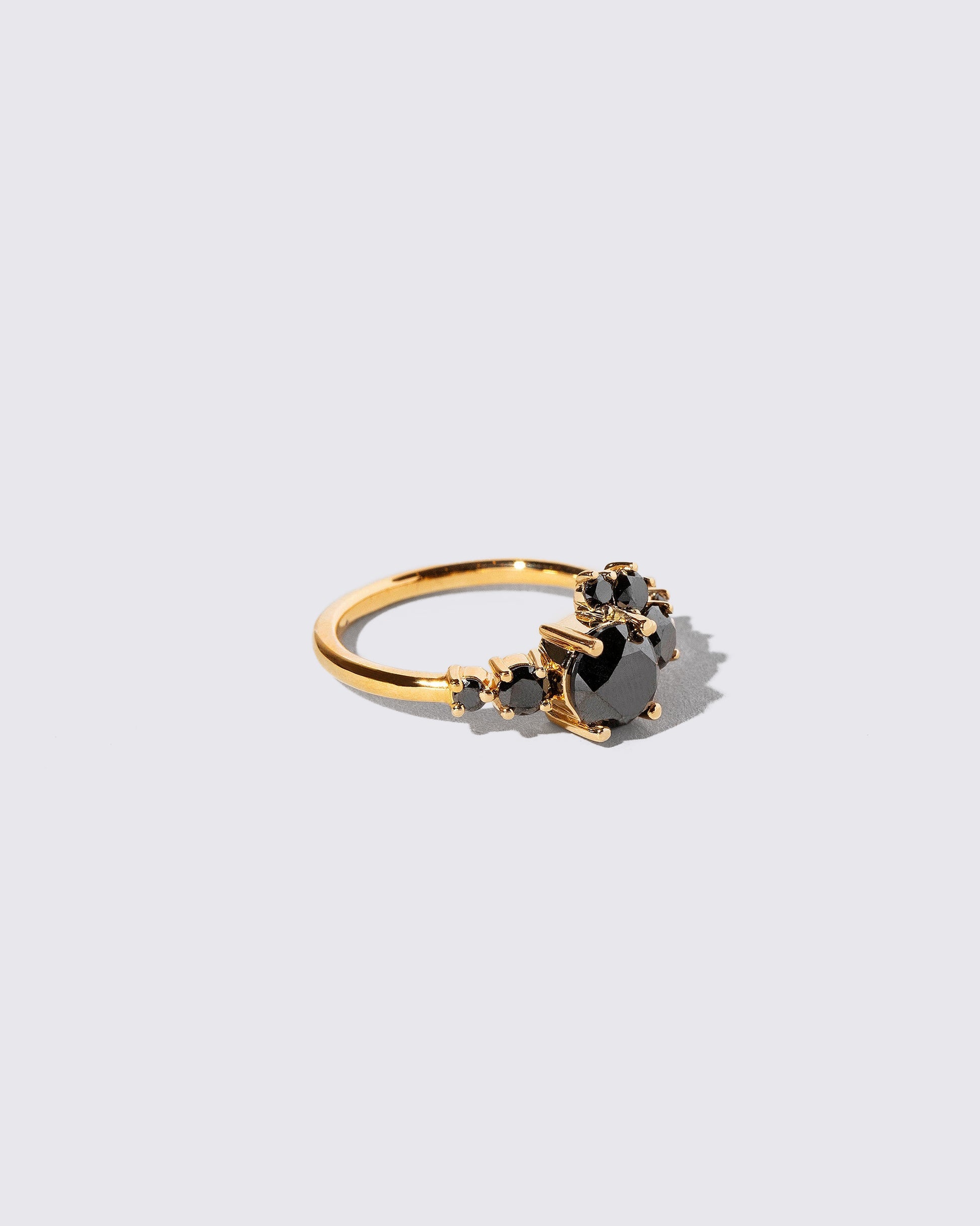 View from the side of the All Black Diamond Luna Ring on light color background.