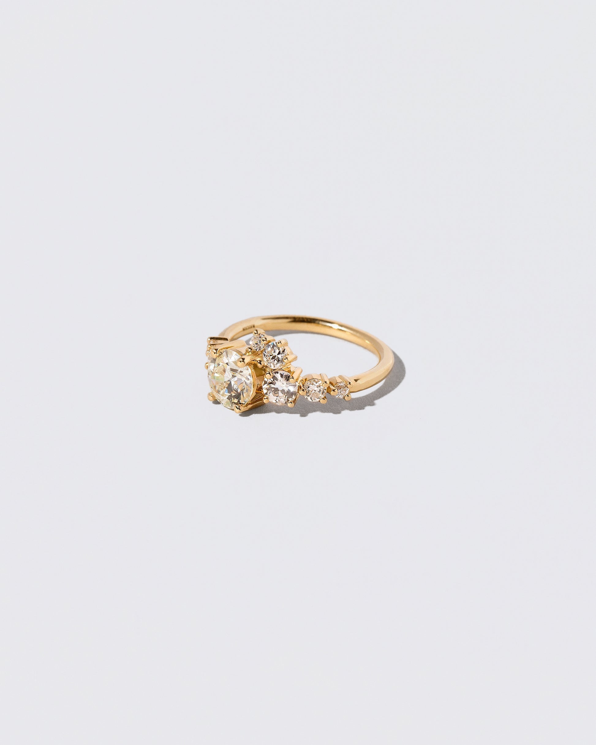 View from the side of the White Diamond Luna Ring on light color background.