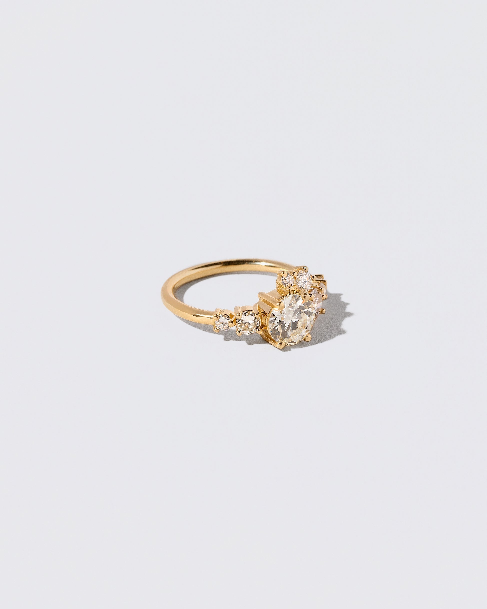 View from the side of the White Diamond Luna Ring on light color background.