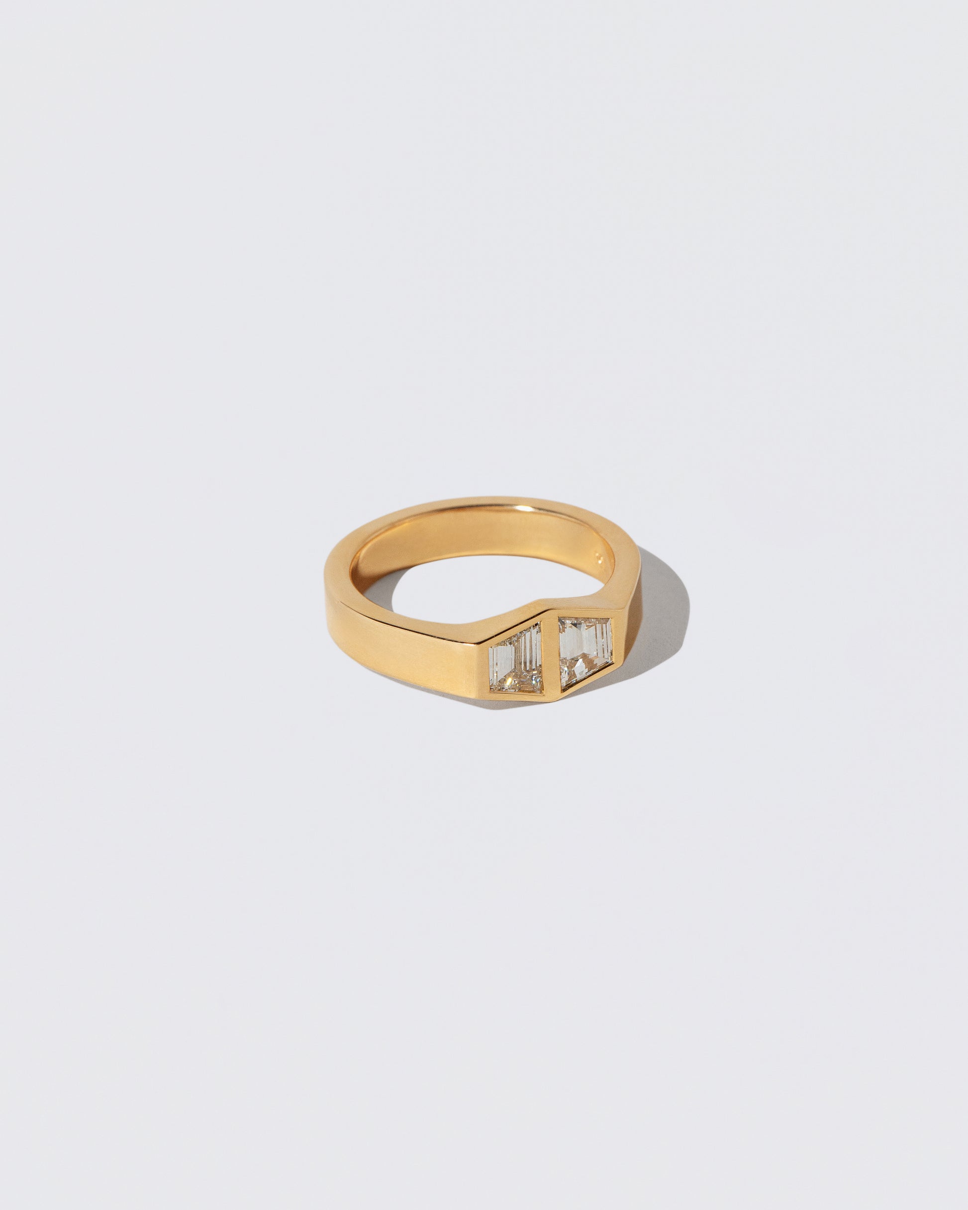 View from the side of the Miroir Ring on light color background.